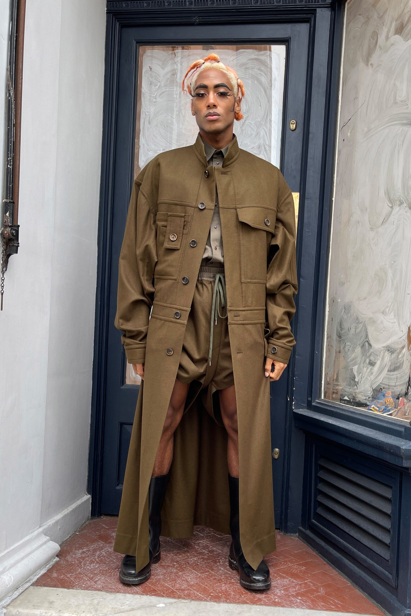 brown relaxed coat with beige shorts