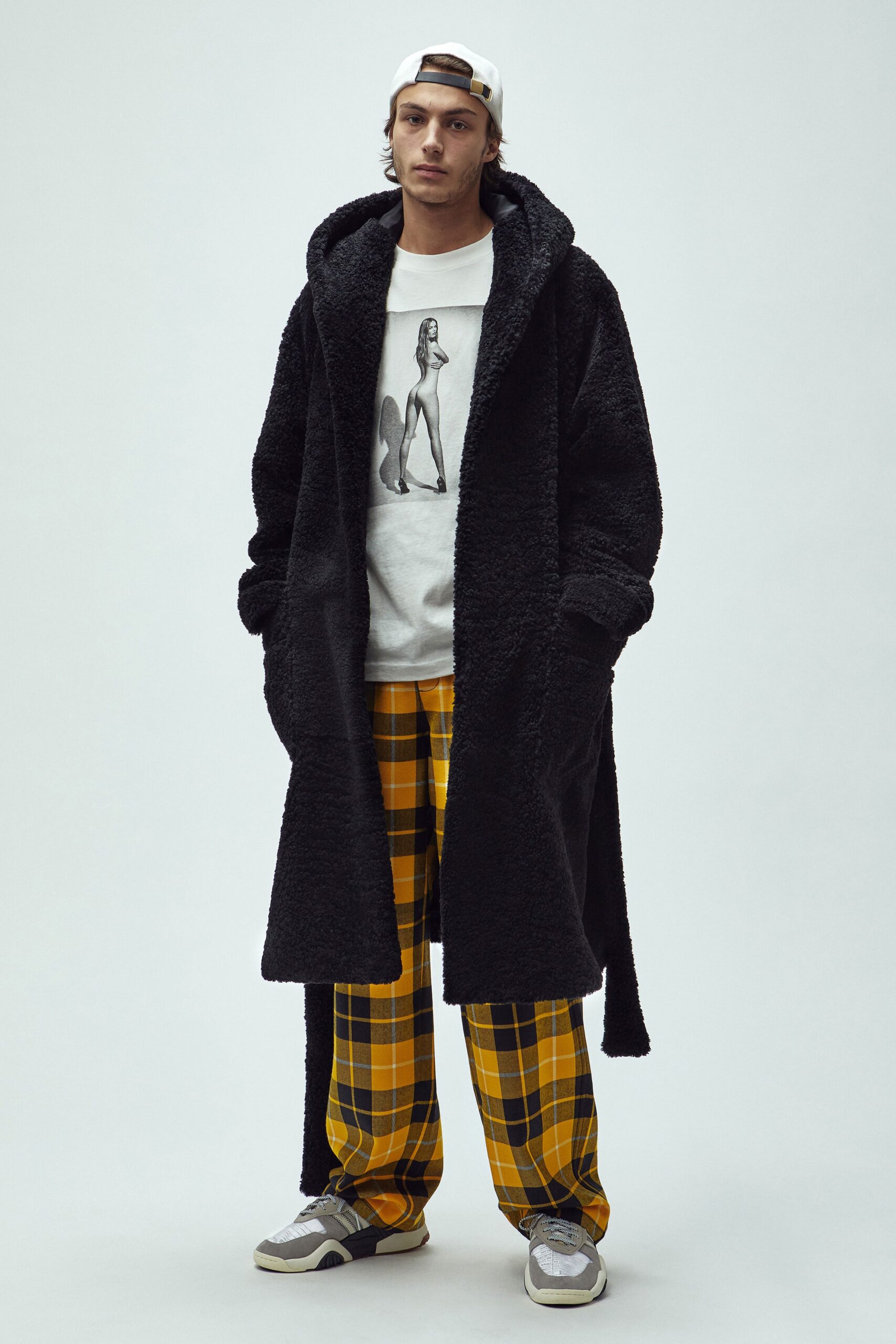 black faux-fur coat with t-shirt and checked pants