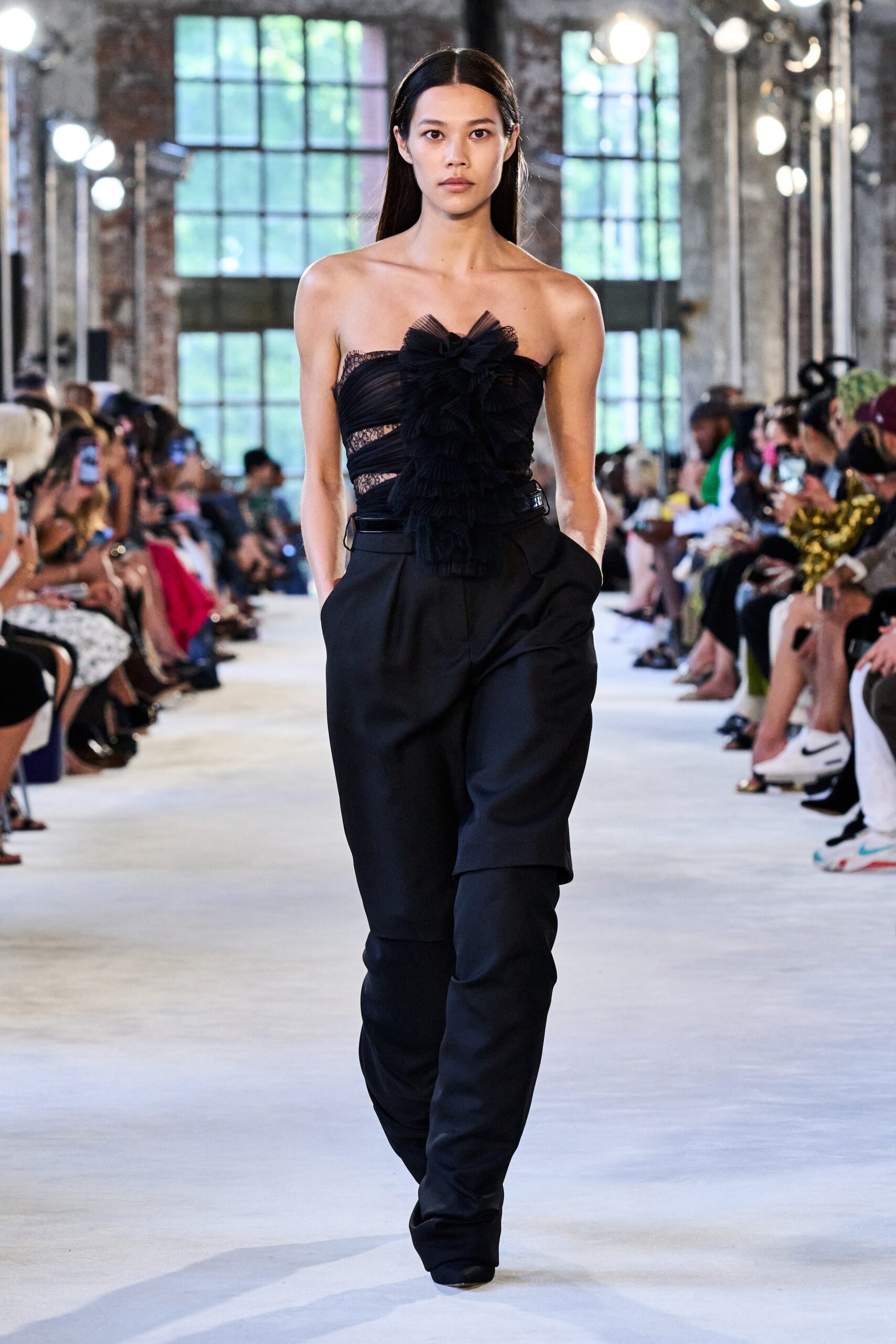 black ruffled strapless top with relaxed pants