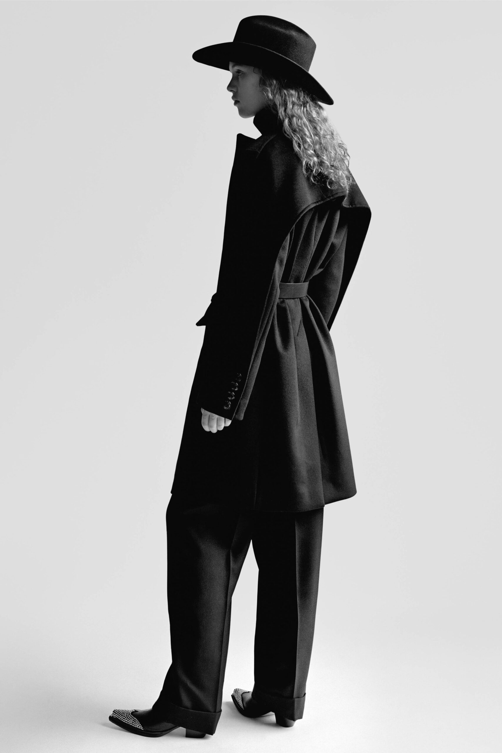 black tailored coat and relaxed pants