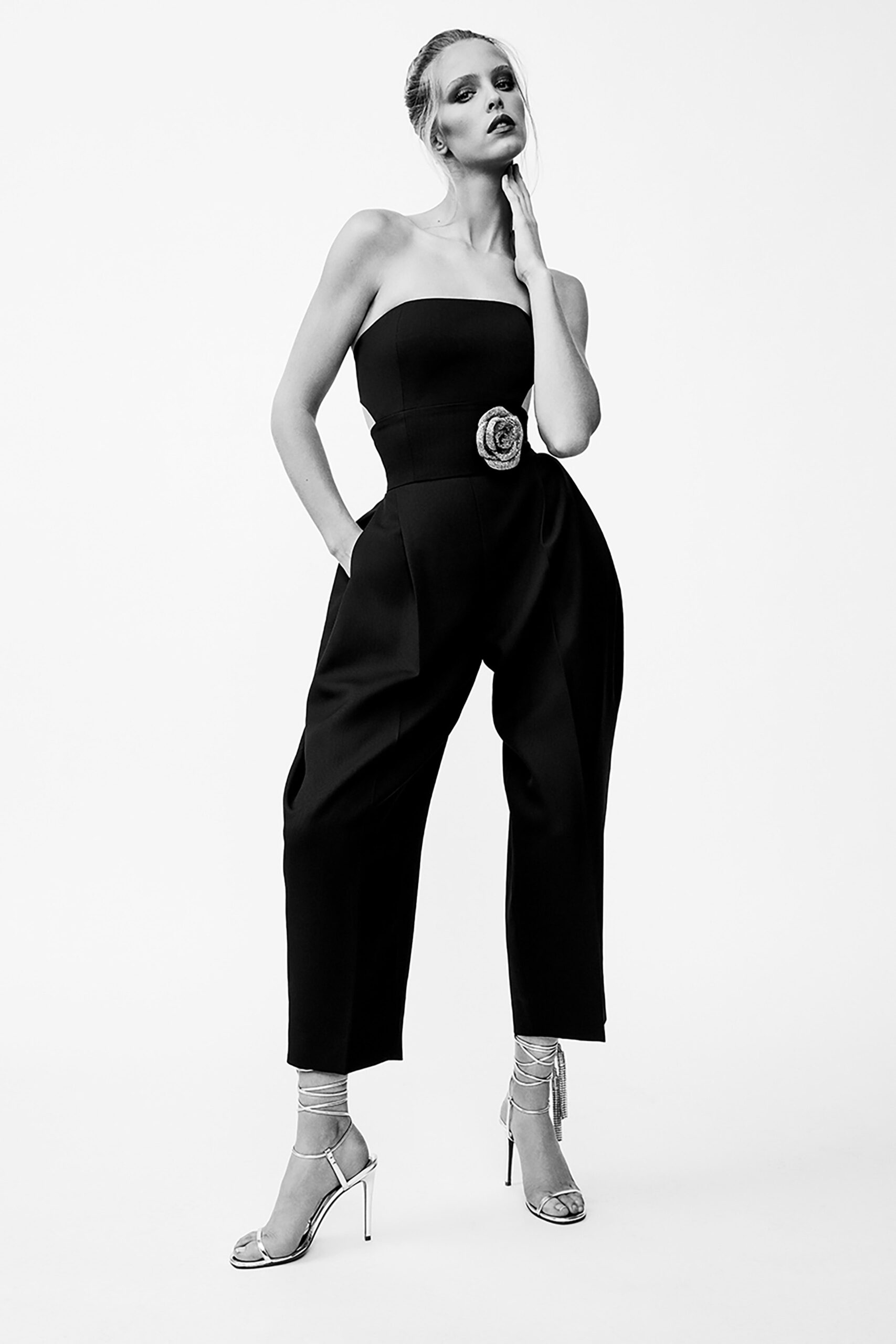 black strapless jumpsuit with silver shoes