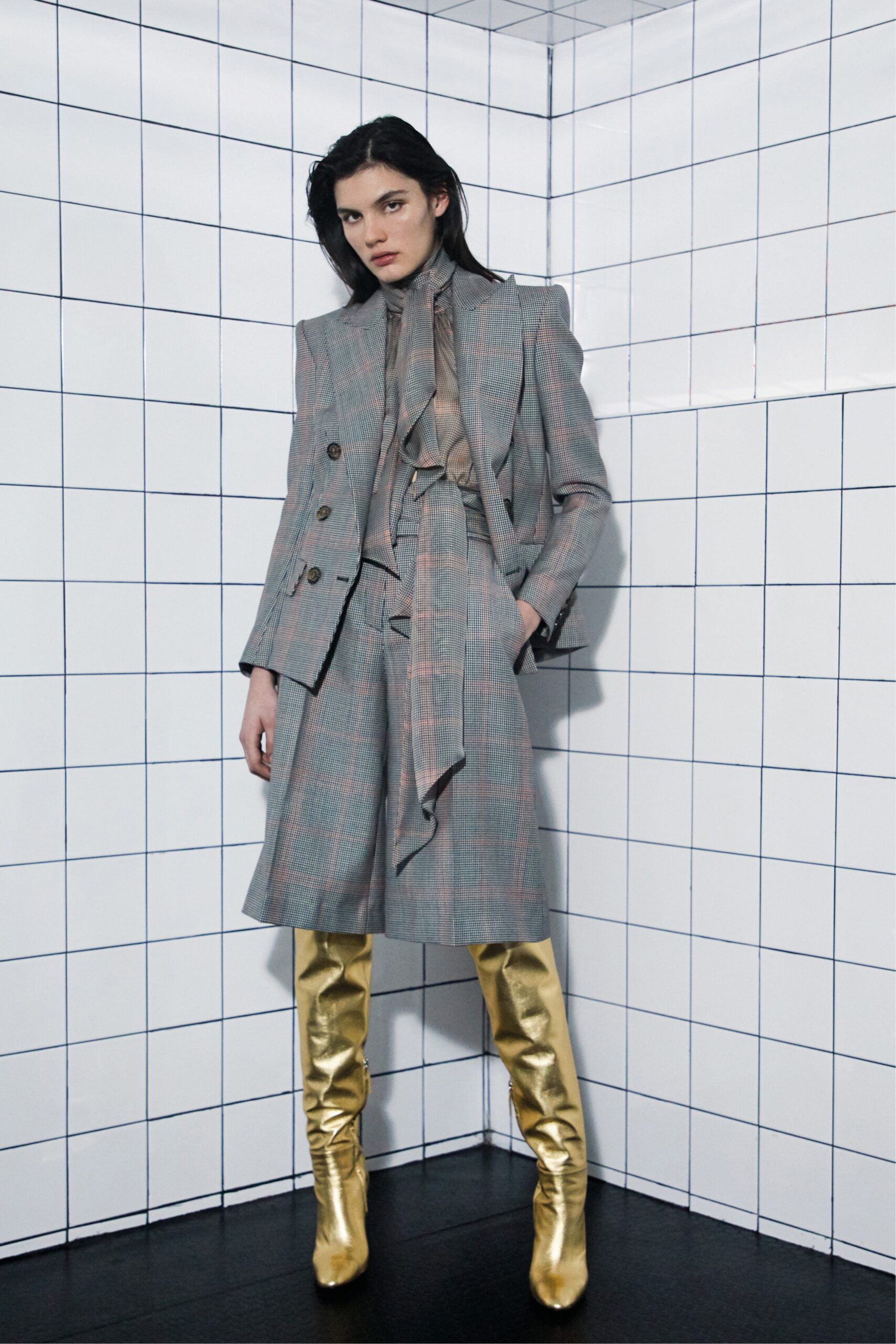 tailored gray suit with gold boots