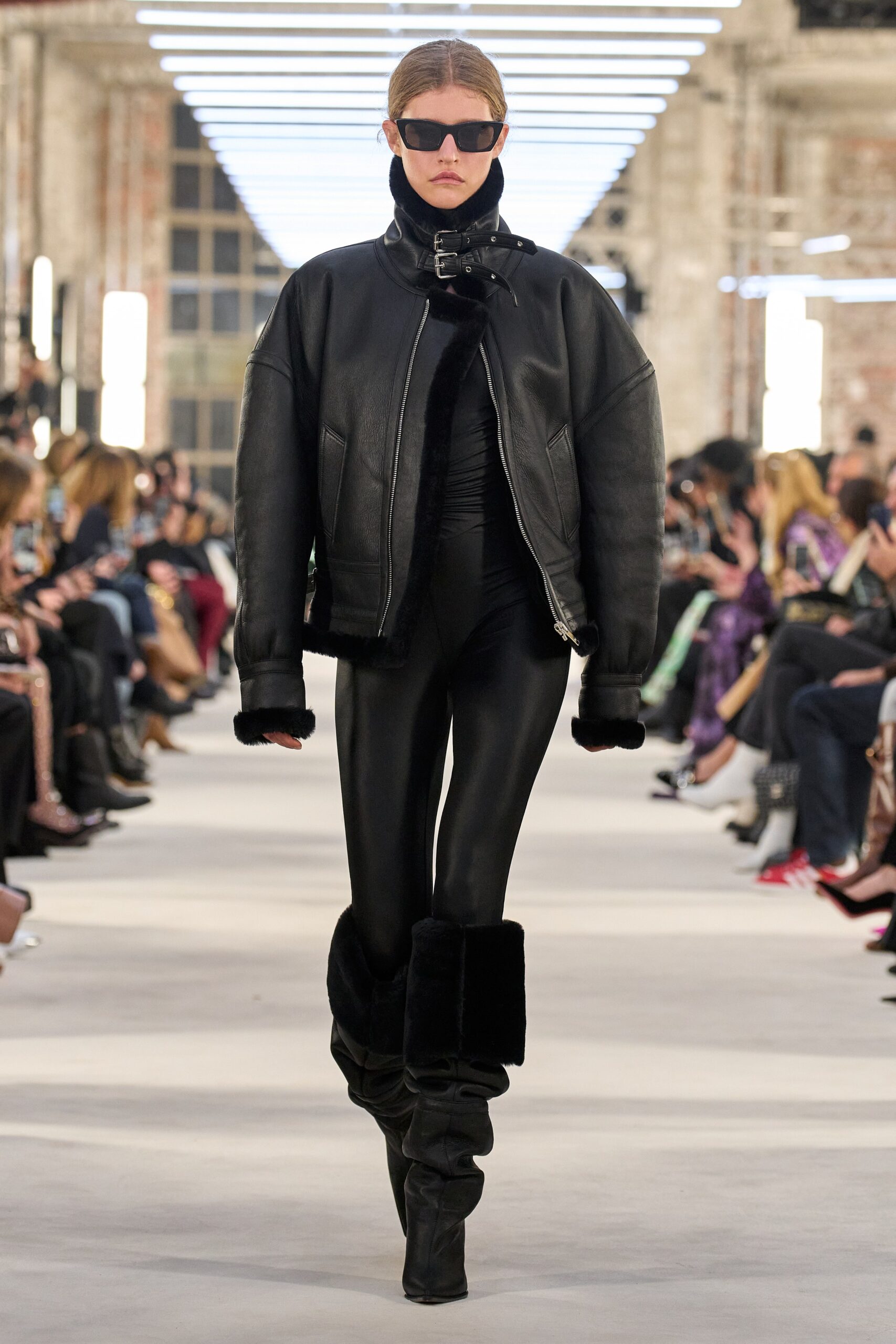 black leather sleeveless high-neck fitted catsuit