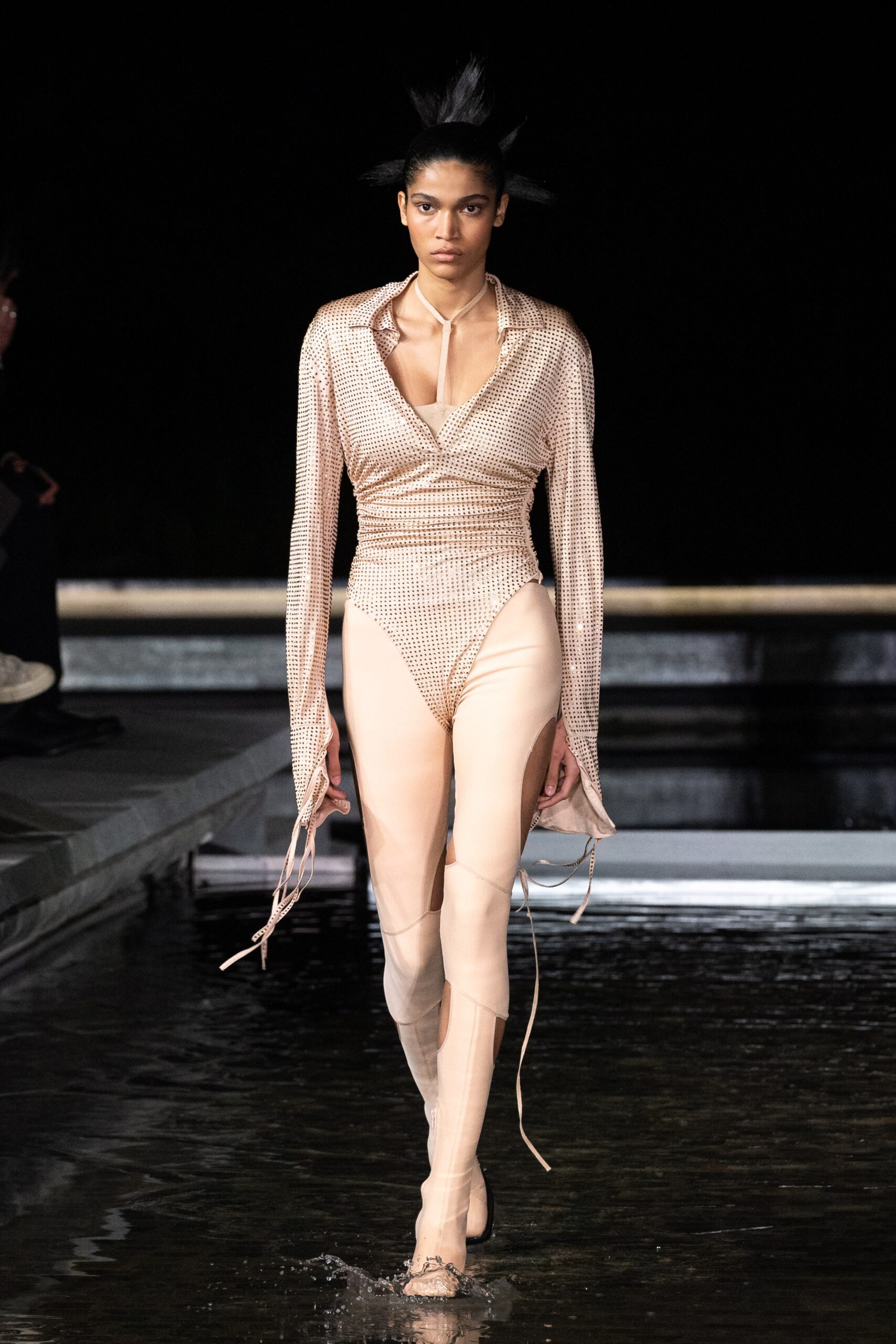 gold mesh bodysuit with beige pants