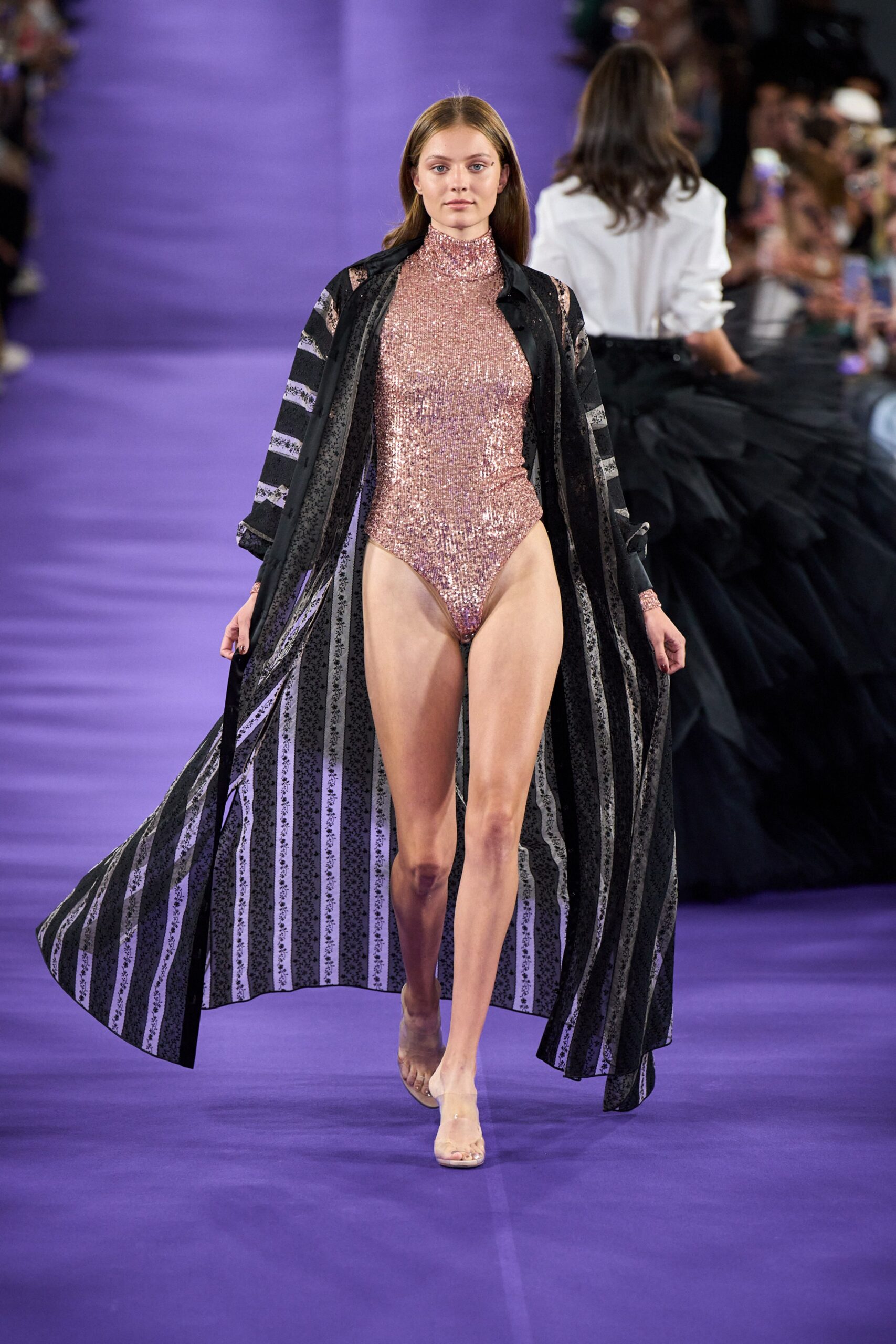 pink sequin swimsuit with black coat