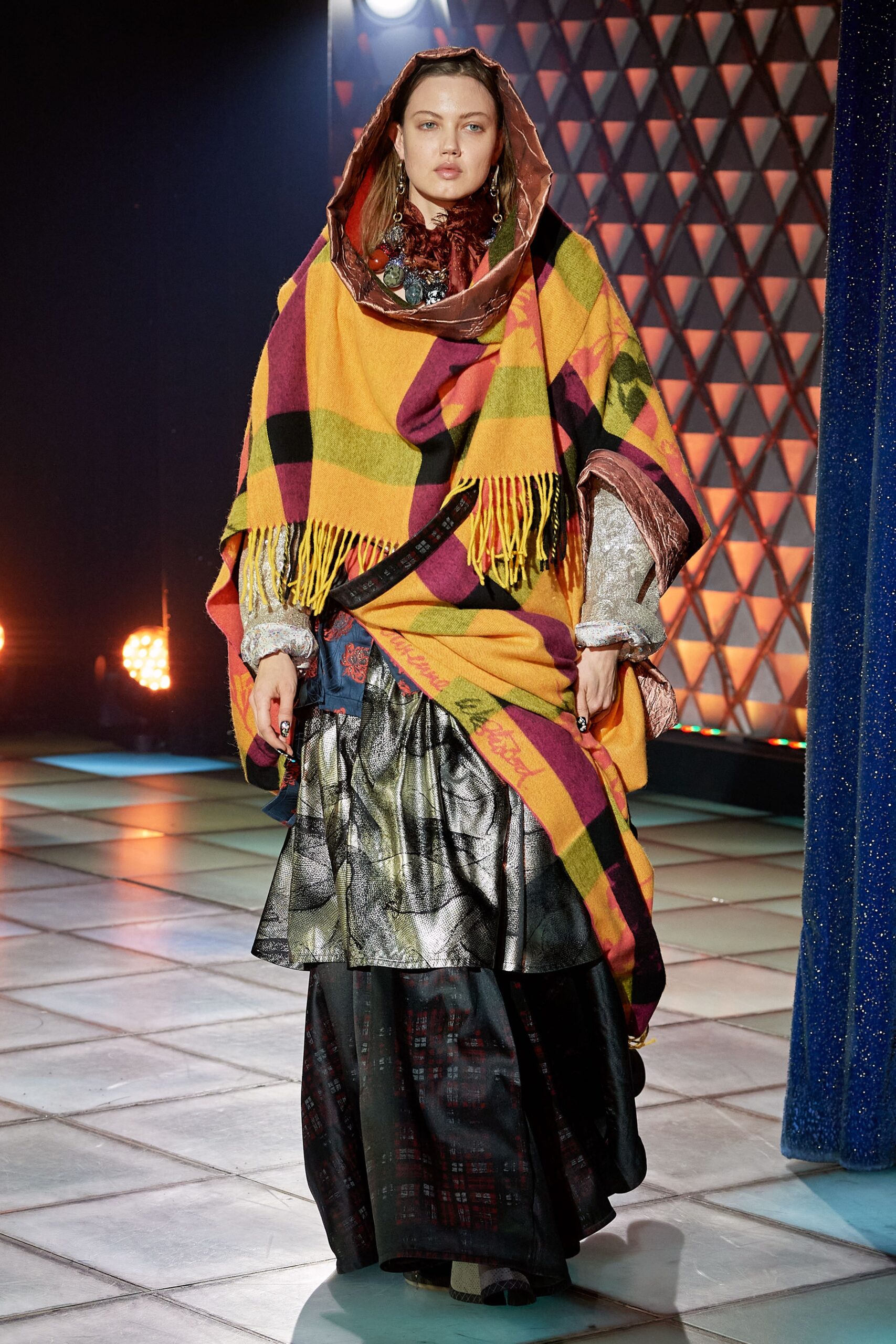 colorful wool poncho and black skirt