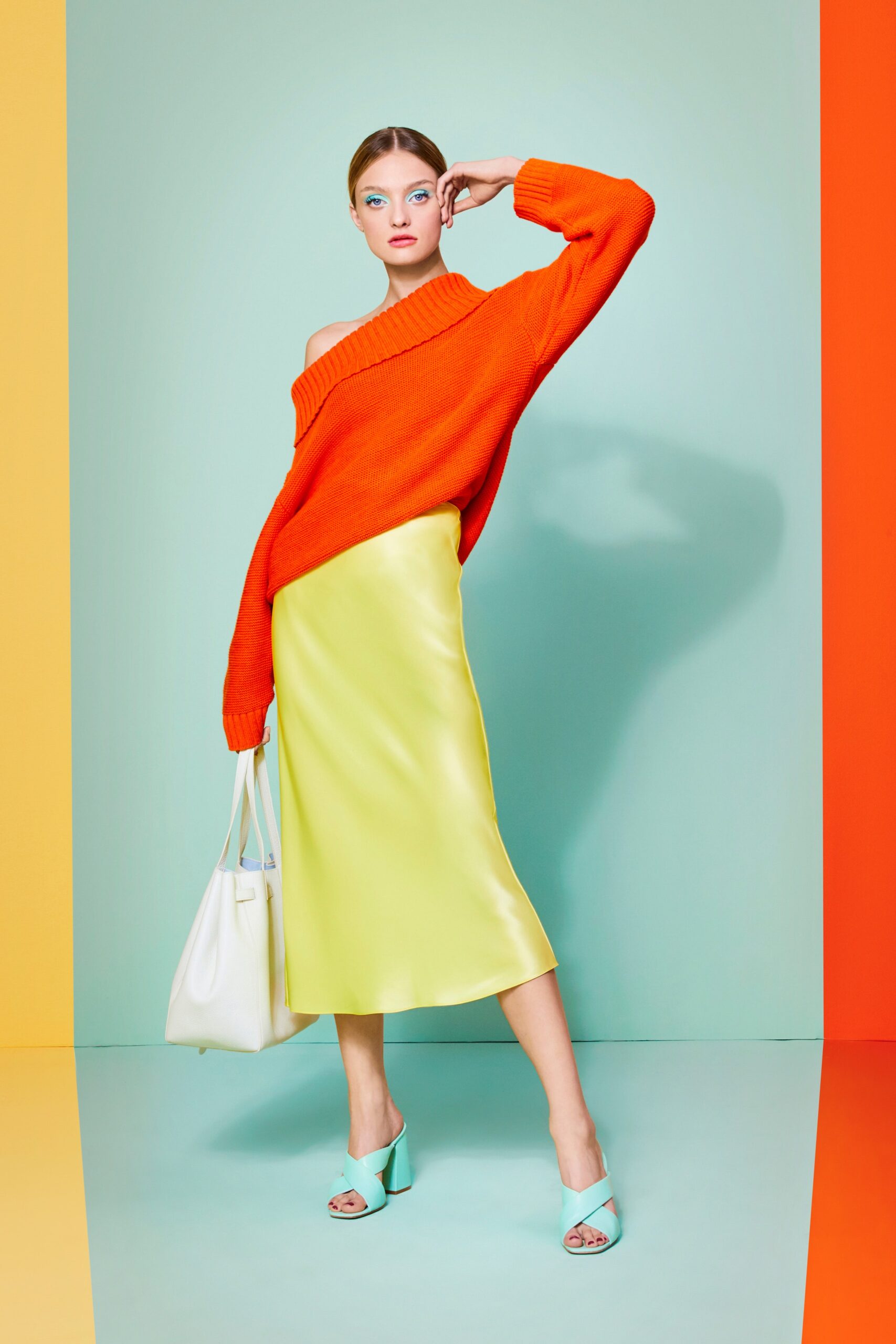 orange wool off-shoulder sweater and yellow silk midi skirt