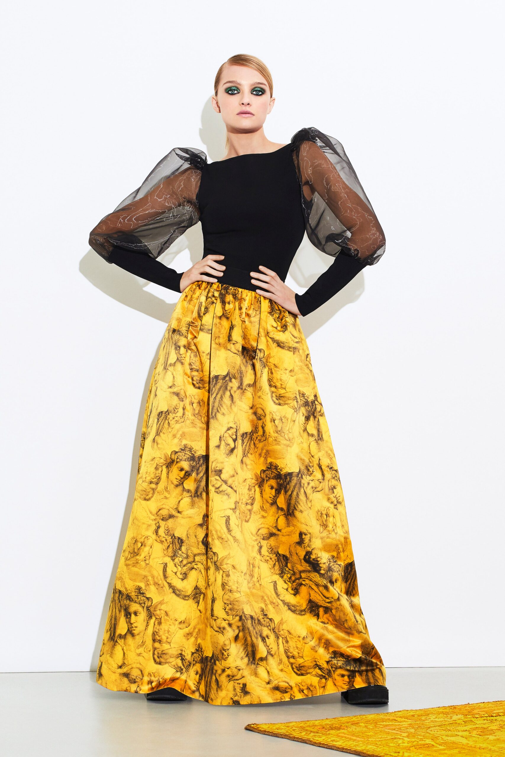 black fitted top with yellow pleated skirt