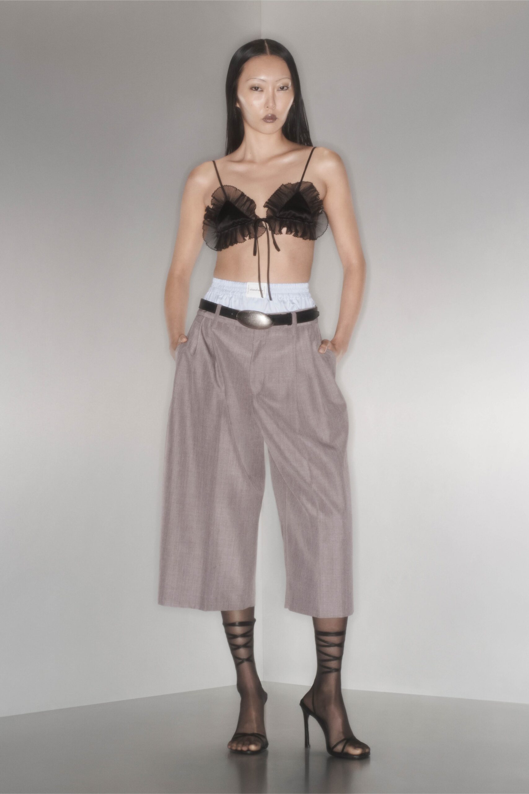 black ruffled top gray wide-leg pants