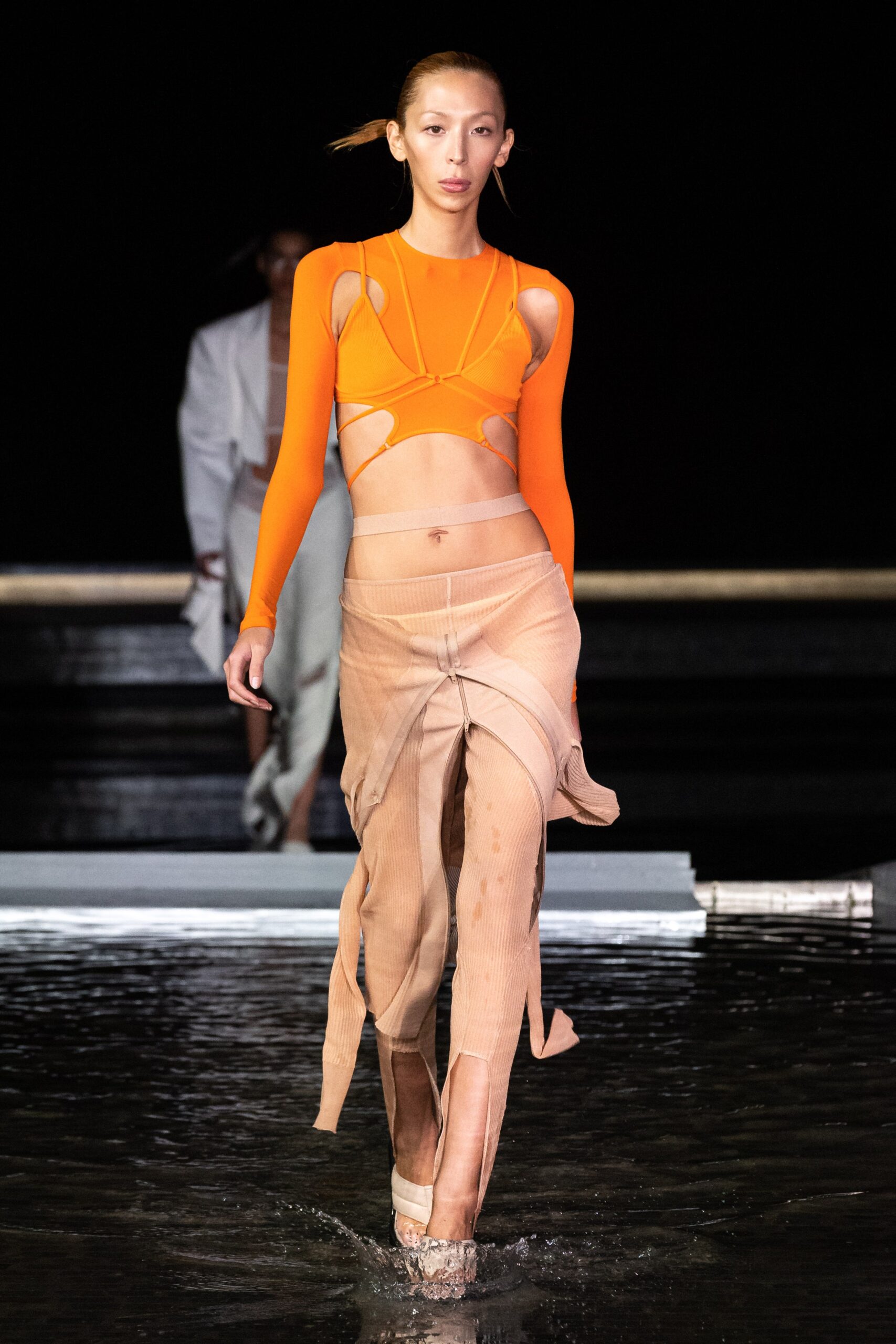 orange cutout top with beige skirt