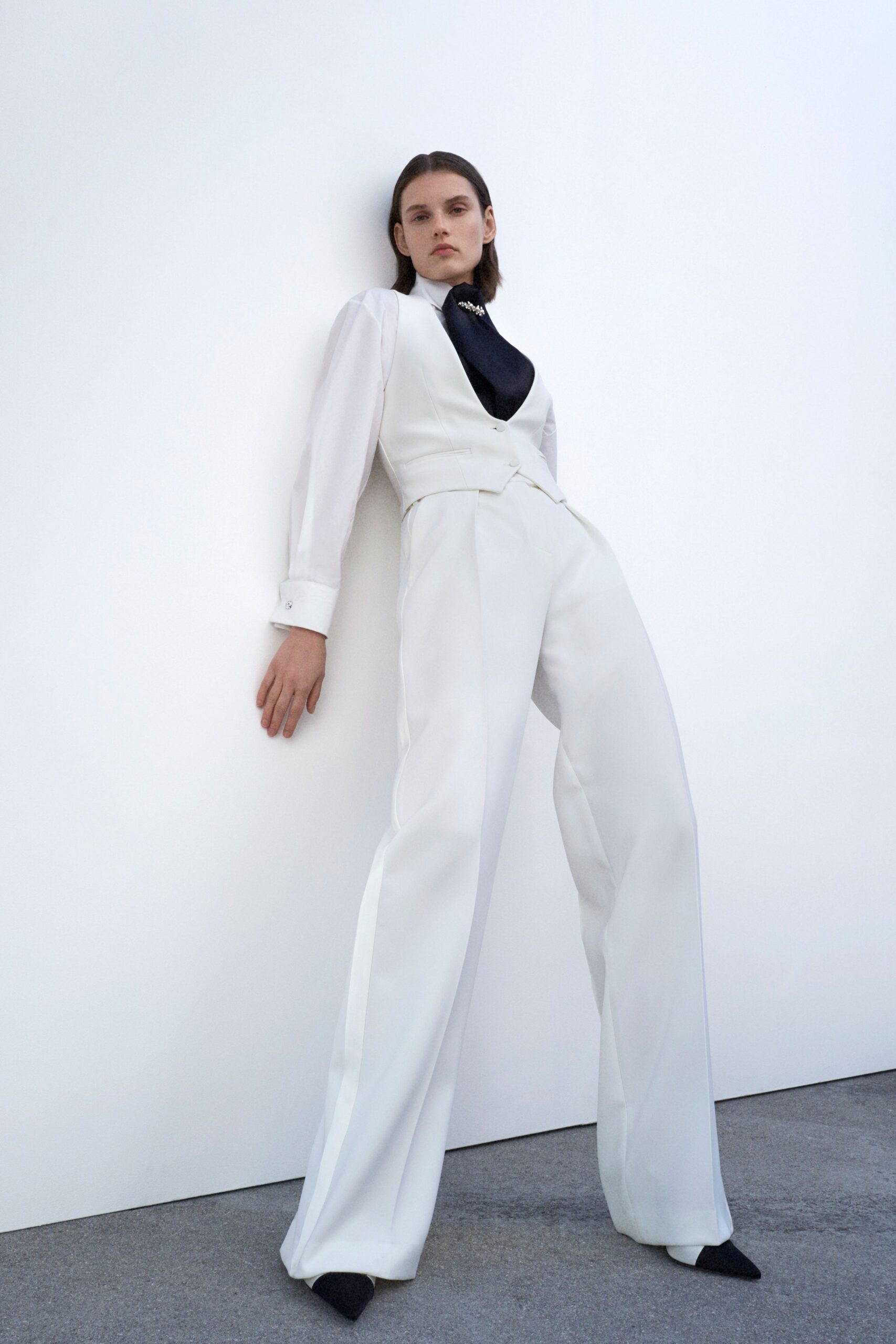 white tailored pants with shirt and black scarf