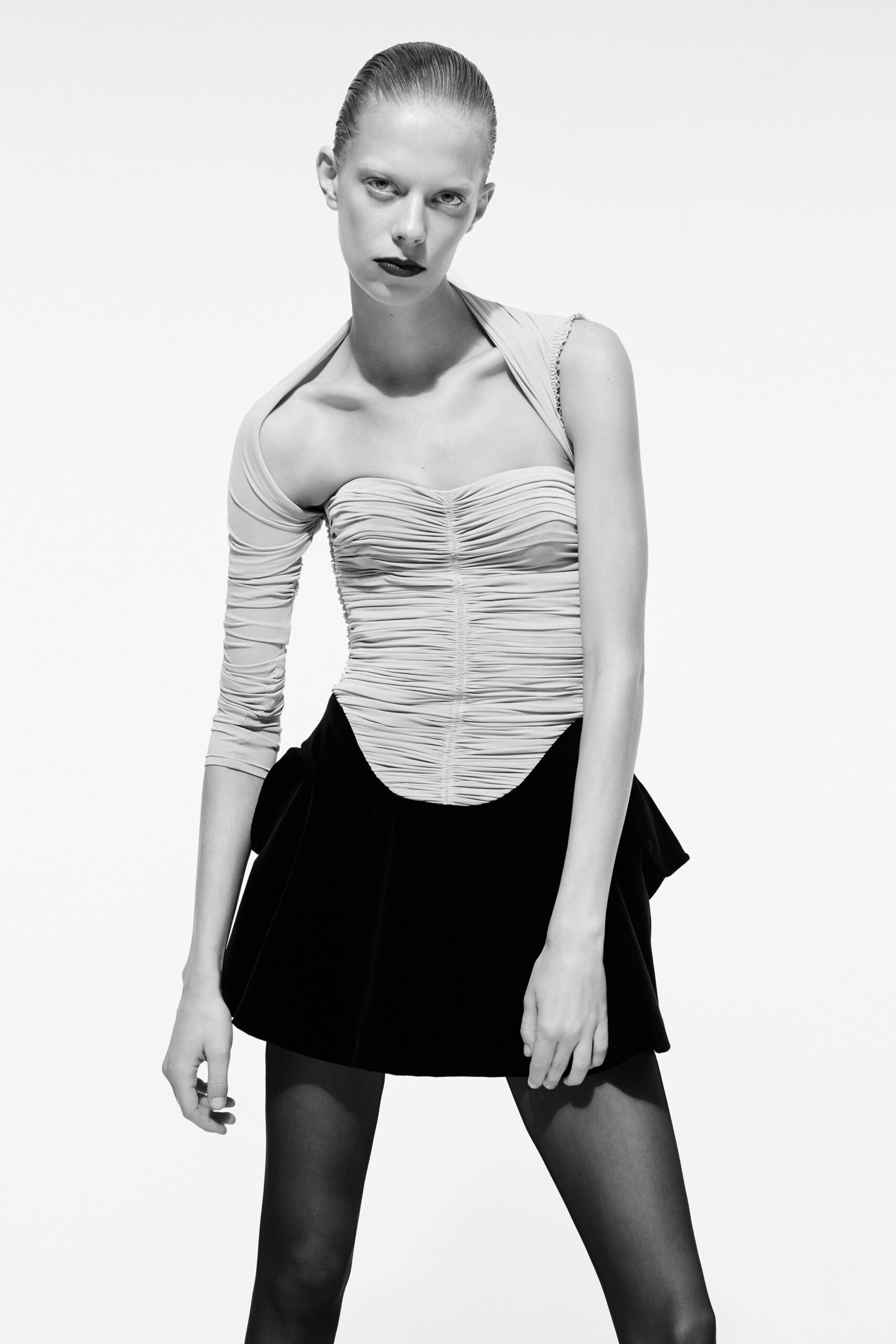 beige fitted top with black flared skirt
