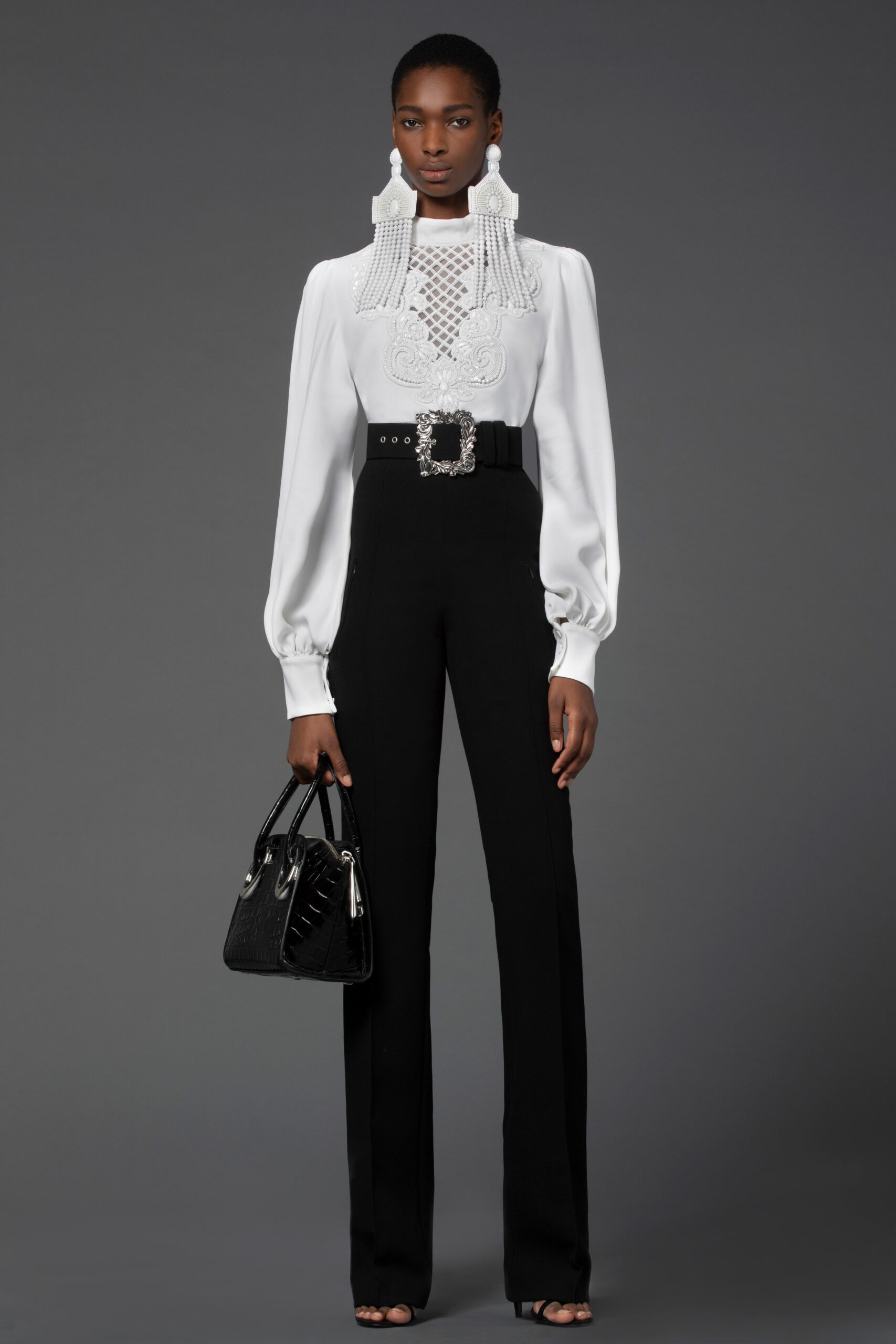 white embroidered blouse and black tailored pants