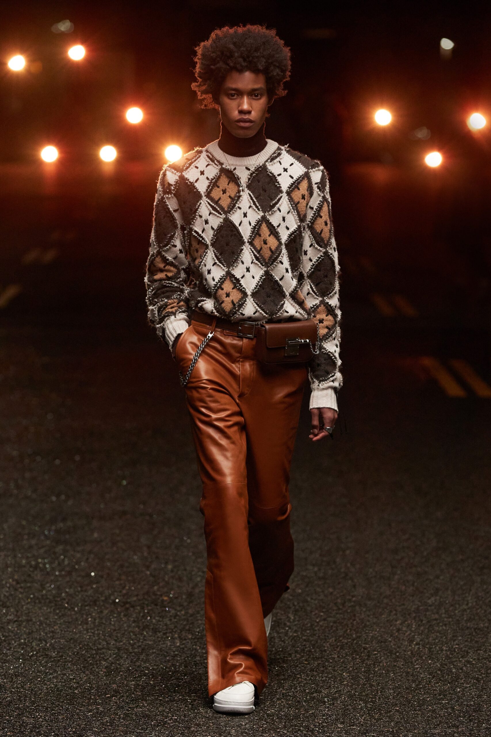 brown argyle sweater and orange leather pants