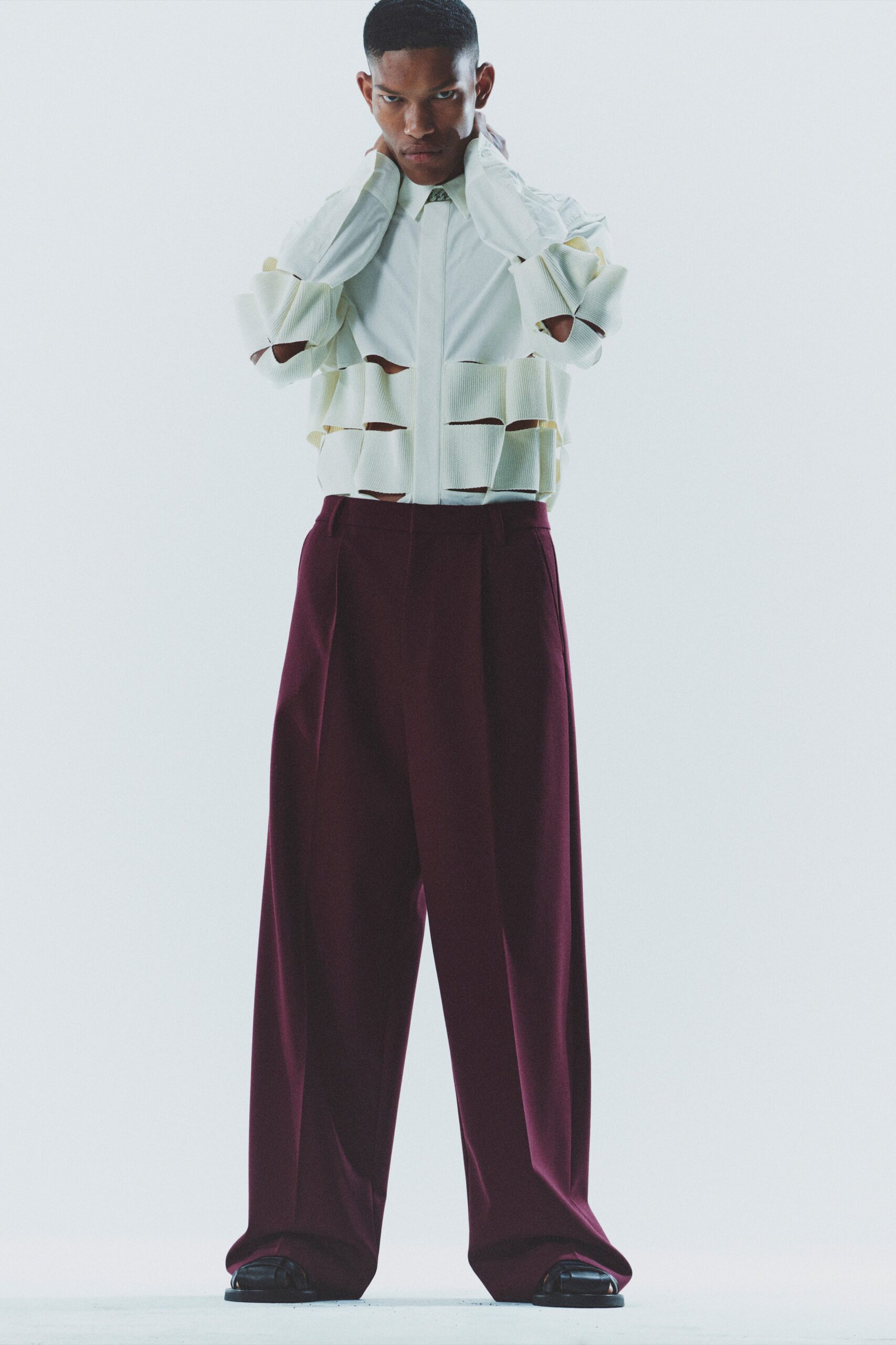 white relaxed shirt and maroon pants
