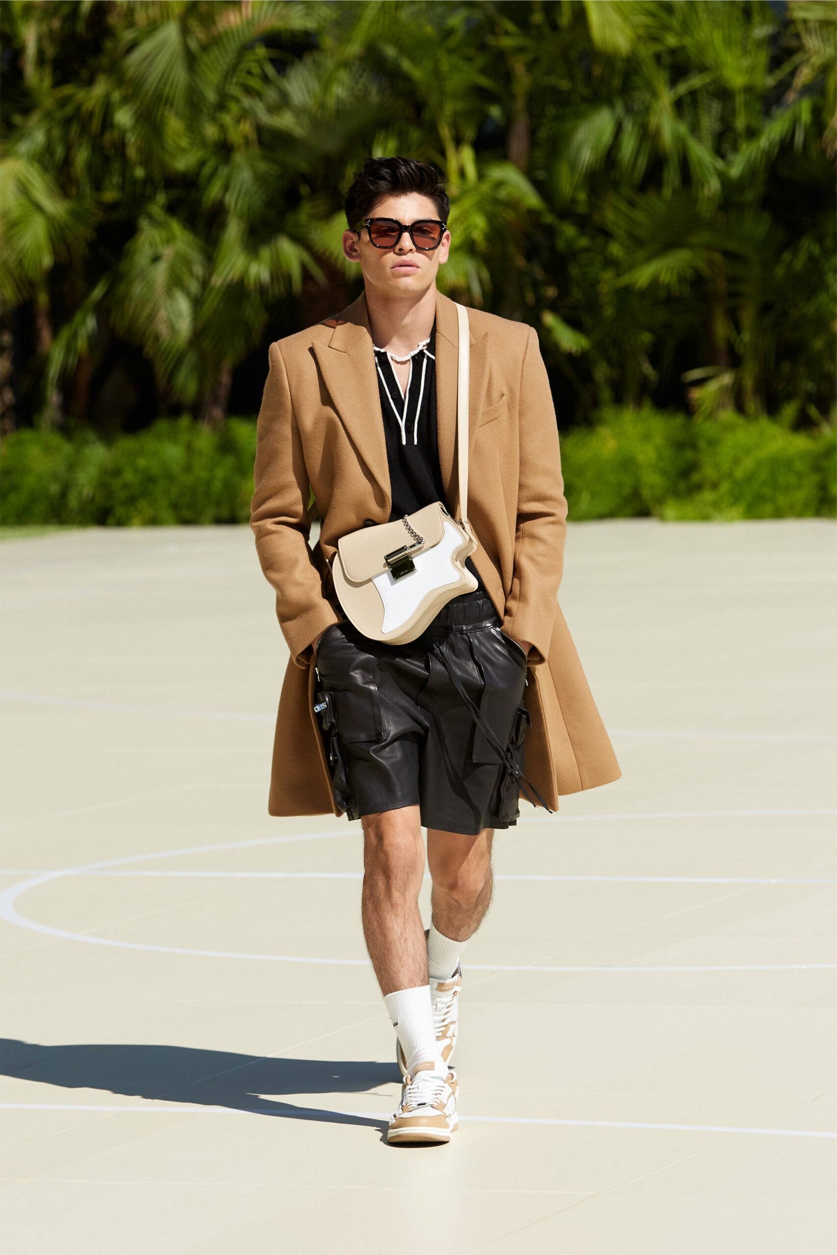 beige tailored coat with black leather shorts