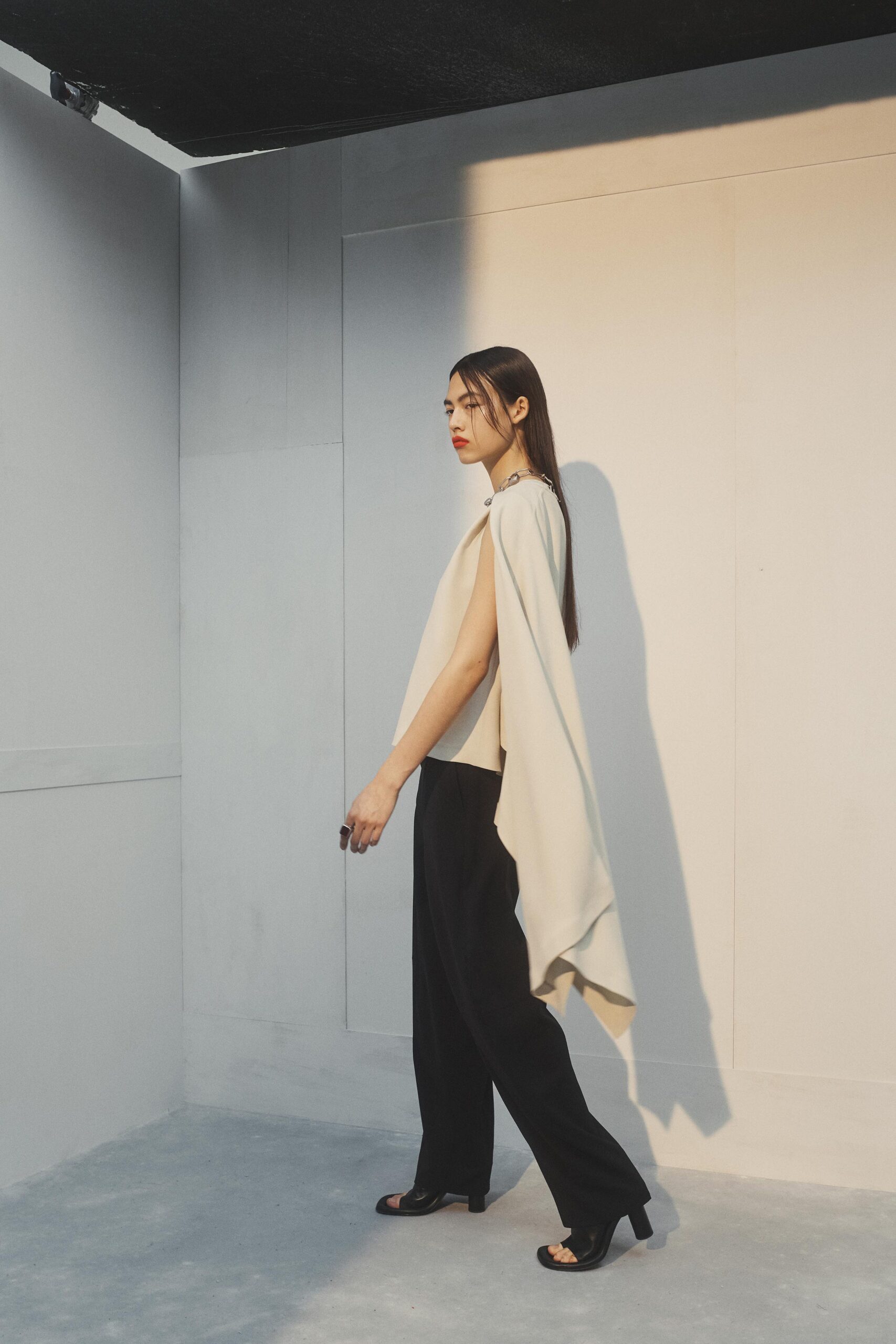white draped top with black pants
