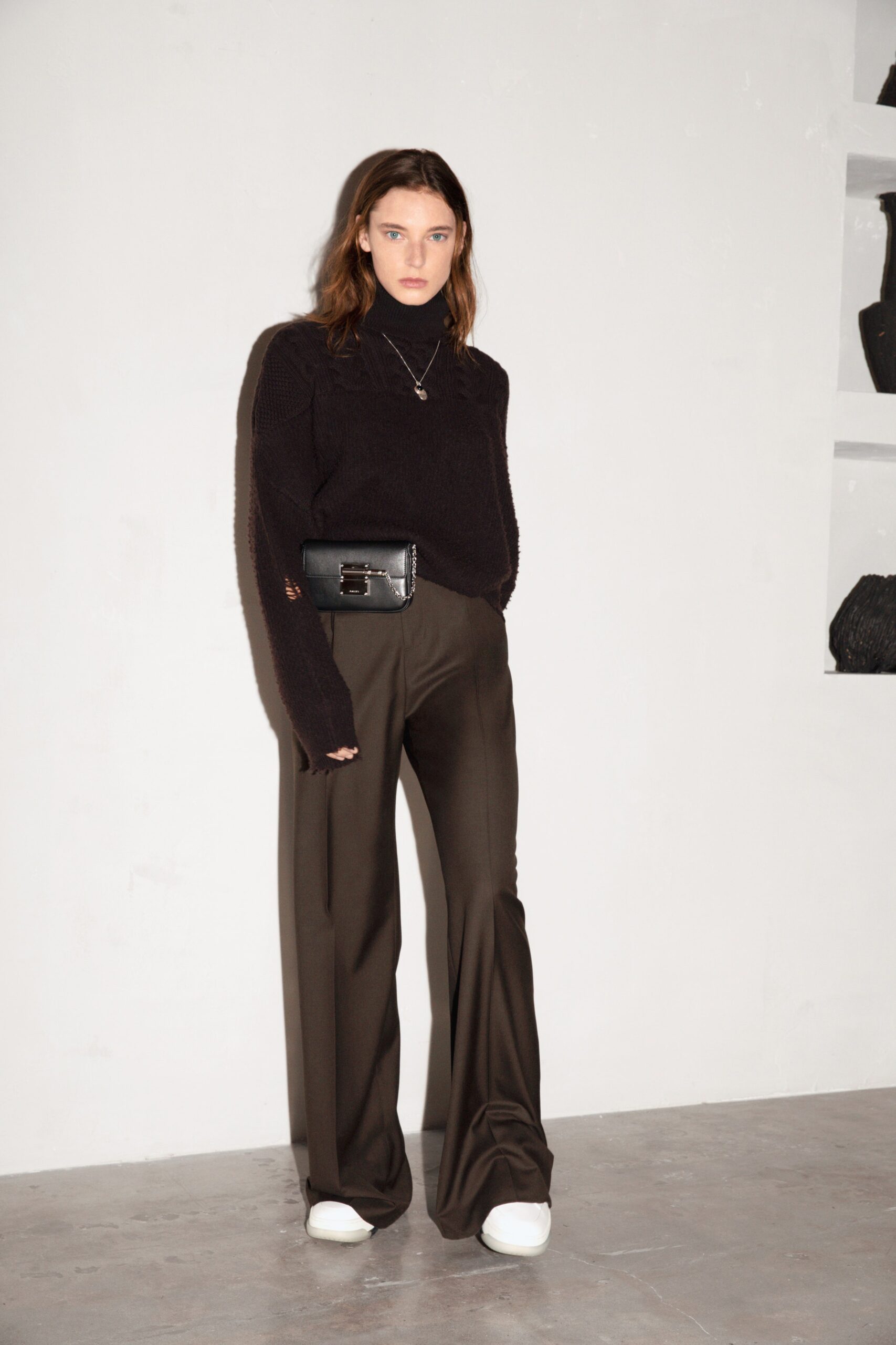 black wool turtleneck sweater and brown flared pants