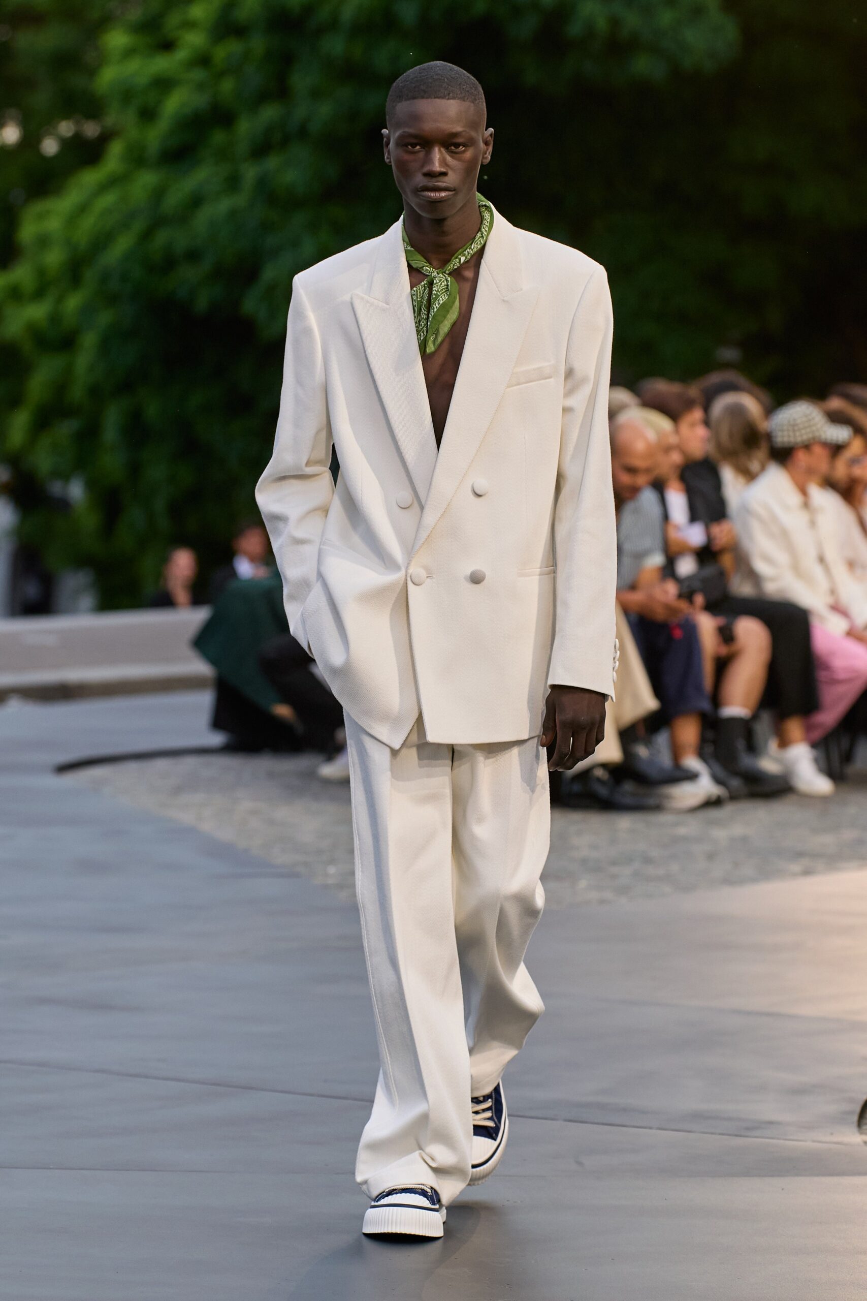 white tailored suit with green scarf