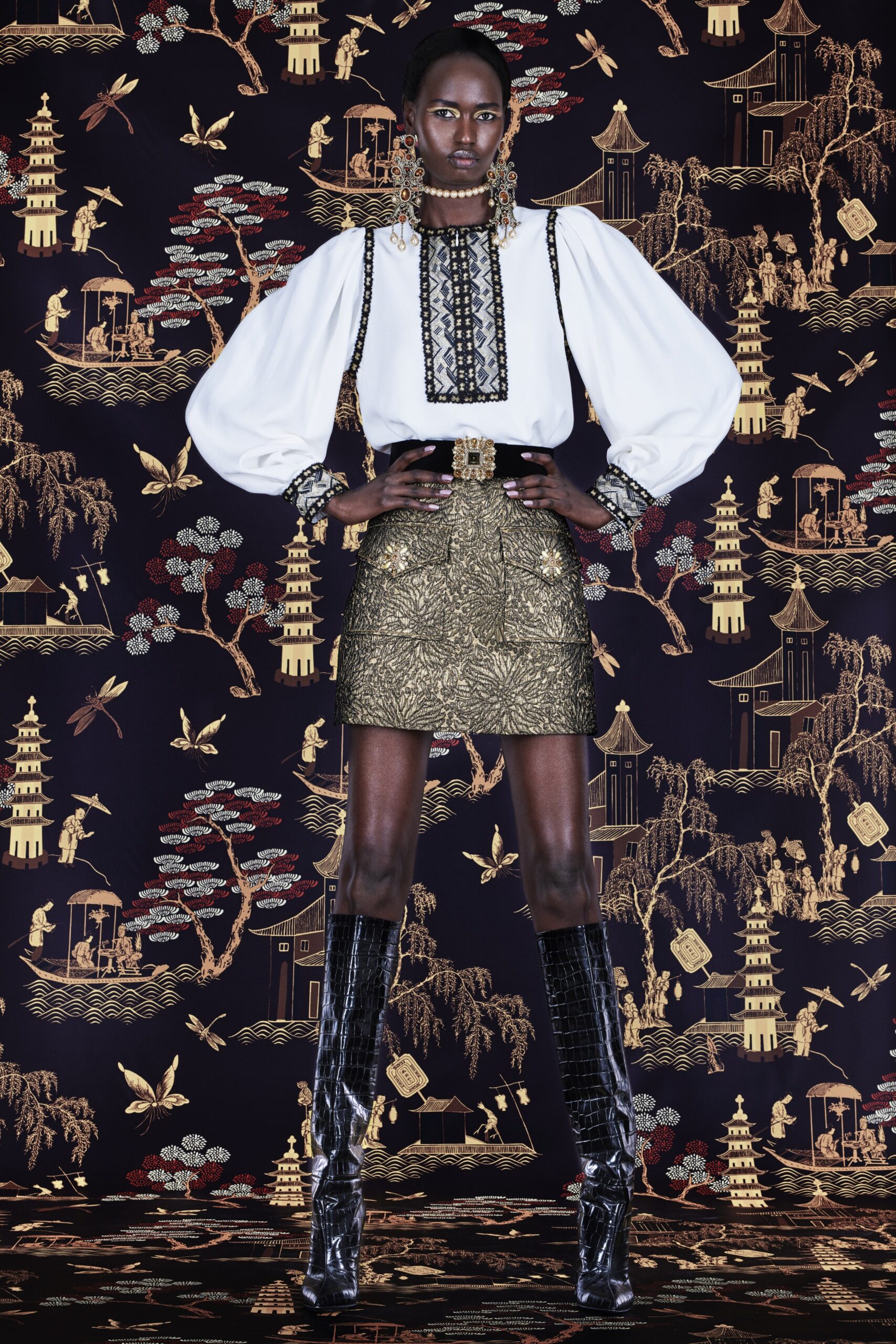 white embroidered blouse and gold mini skirt
