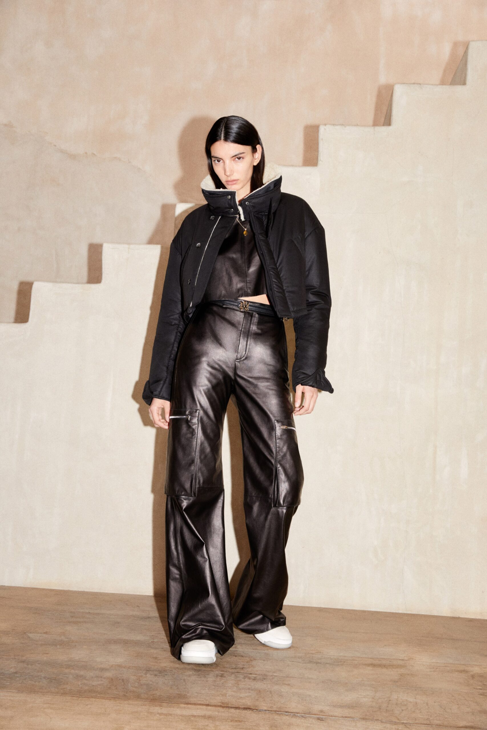 black leather fitted jacket and relaxed pants