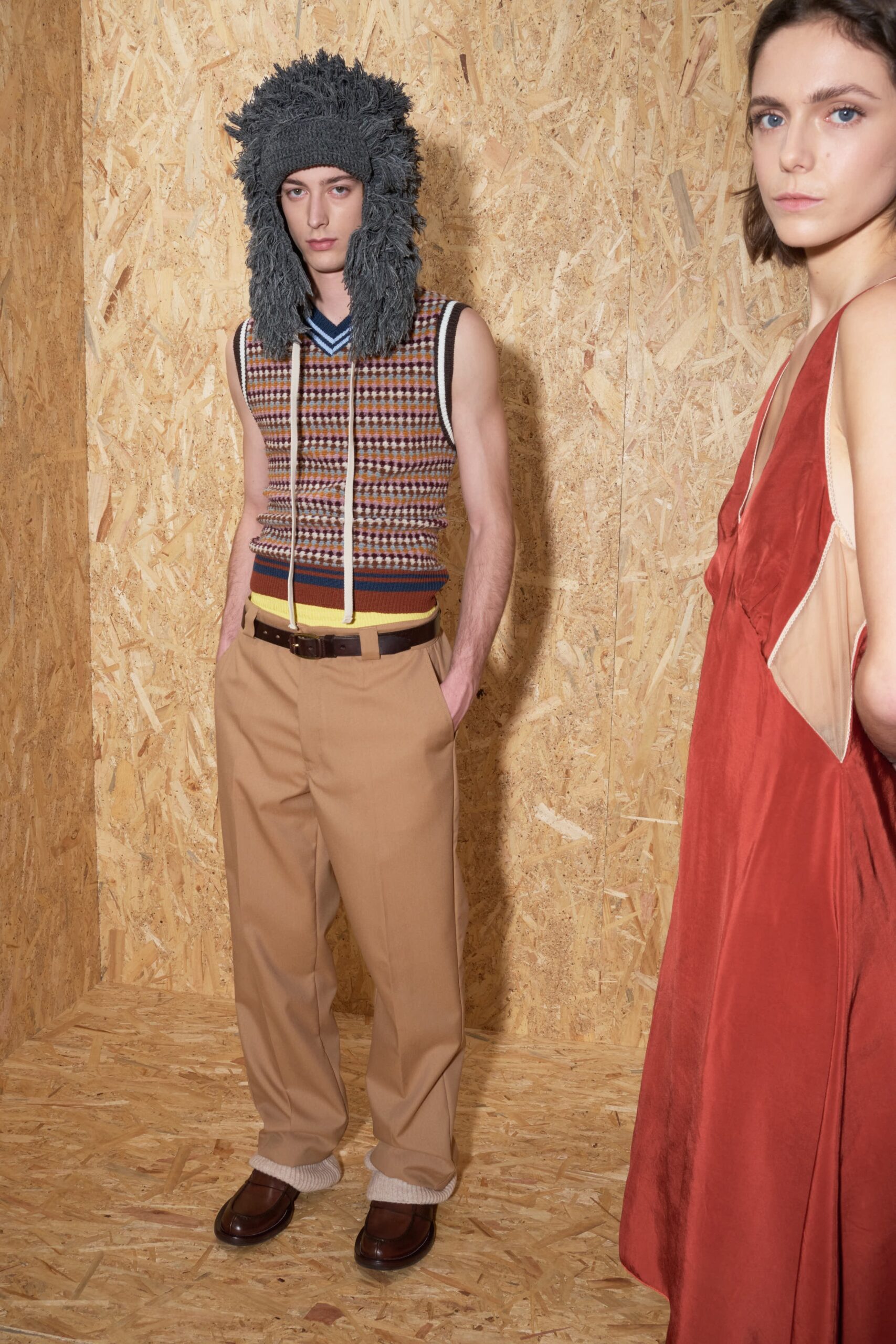 multi-colored sleeveless top and beige pants