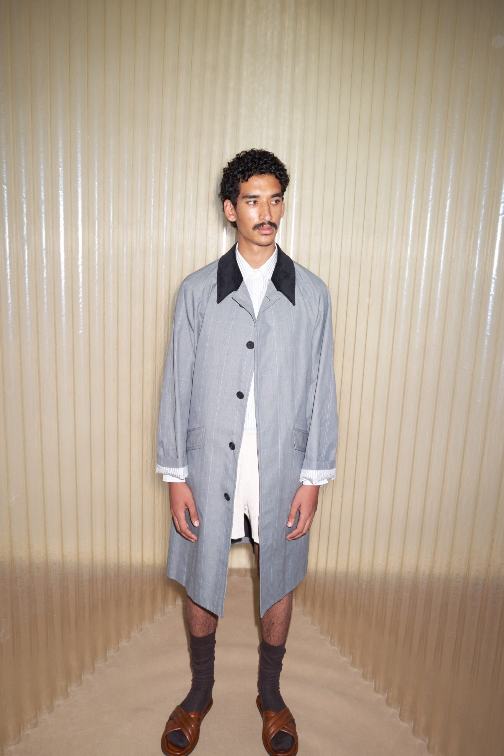 gray coat with white shirt and shorts