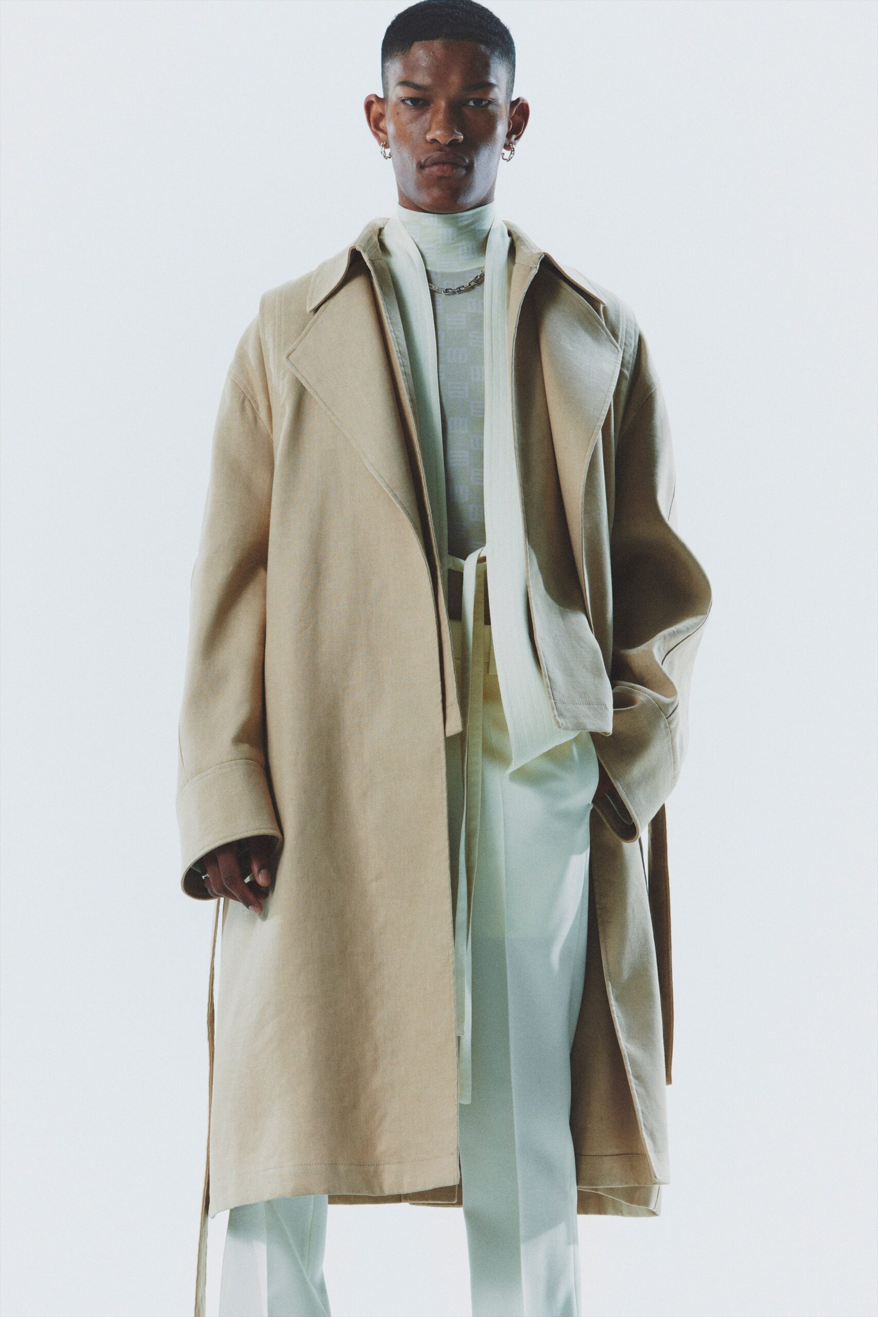 beige oversized coat with white shirt and tailored pants