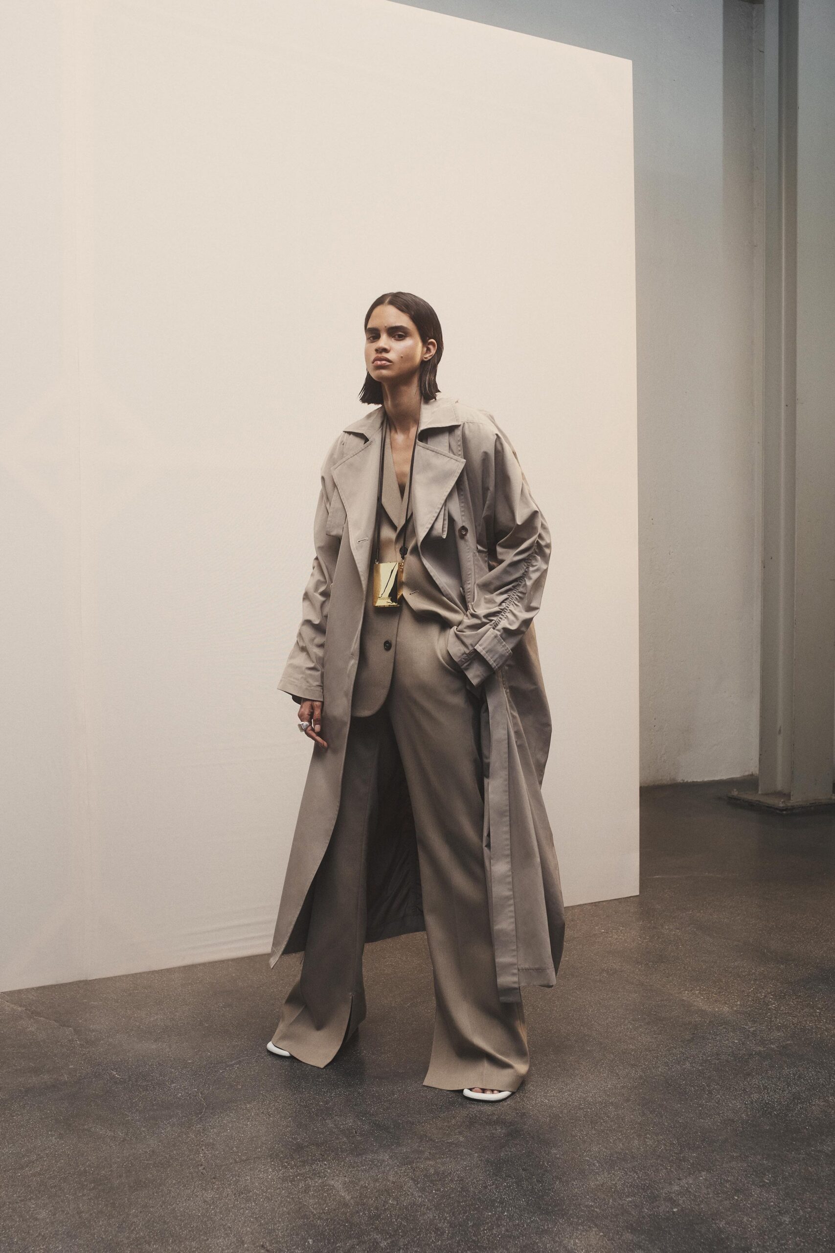 beige relaxed trench coat and tailored pants