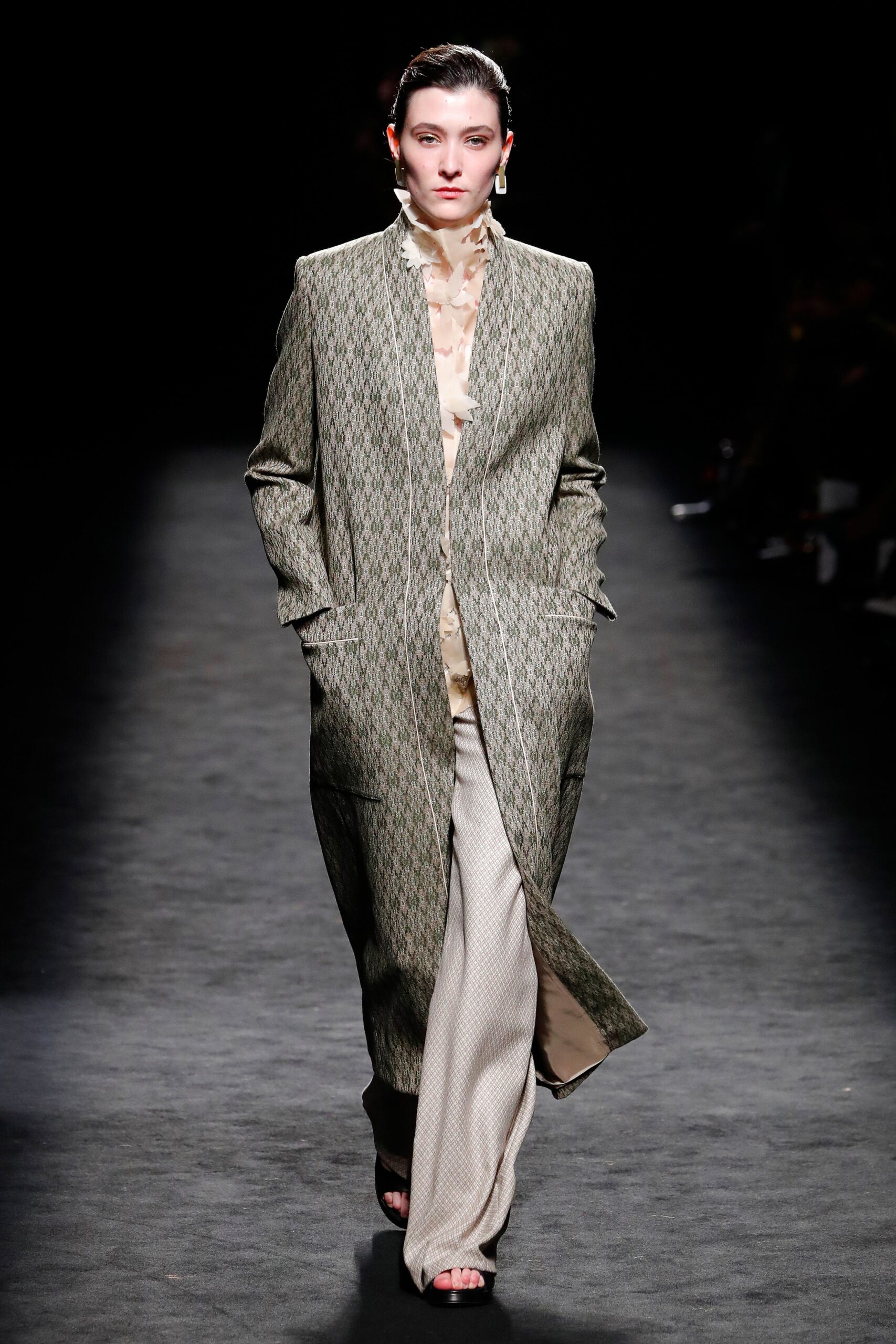 green printed silk coat with beige pants