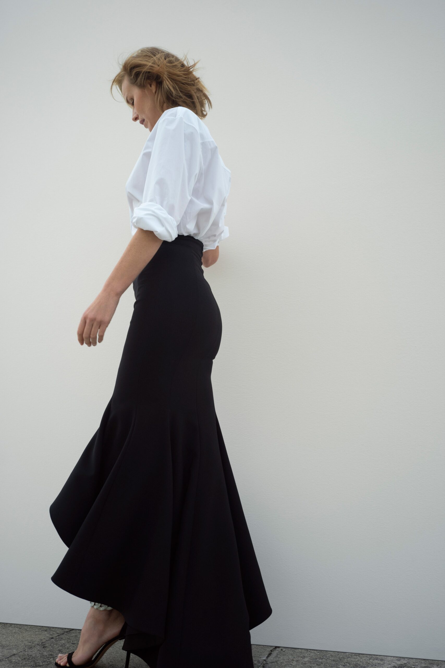 white blouse and black flared skirt