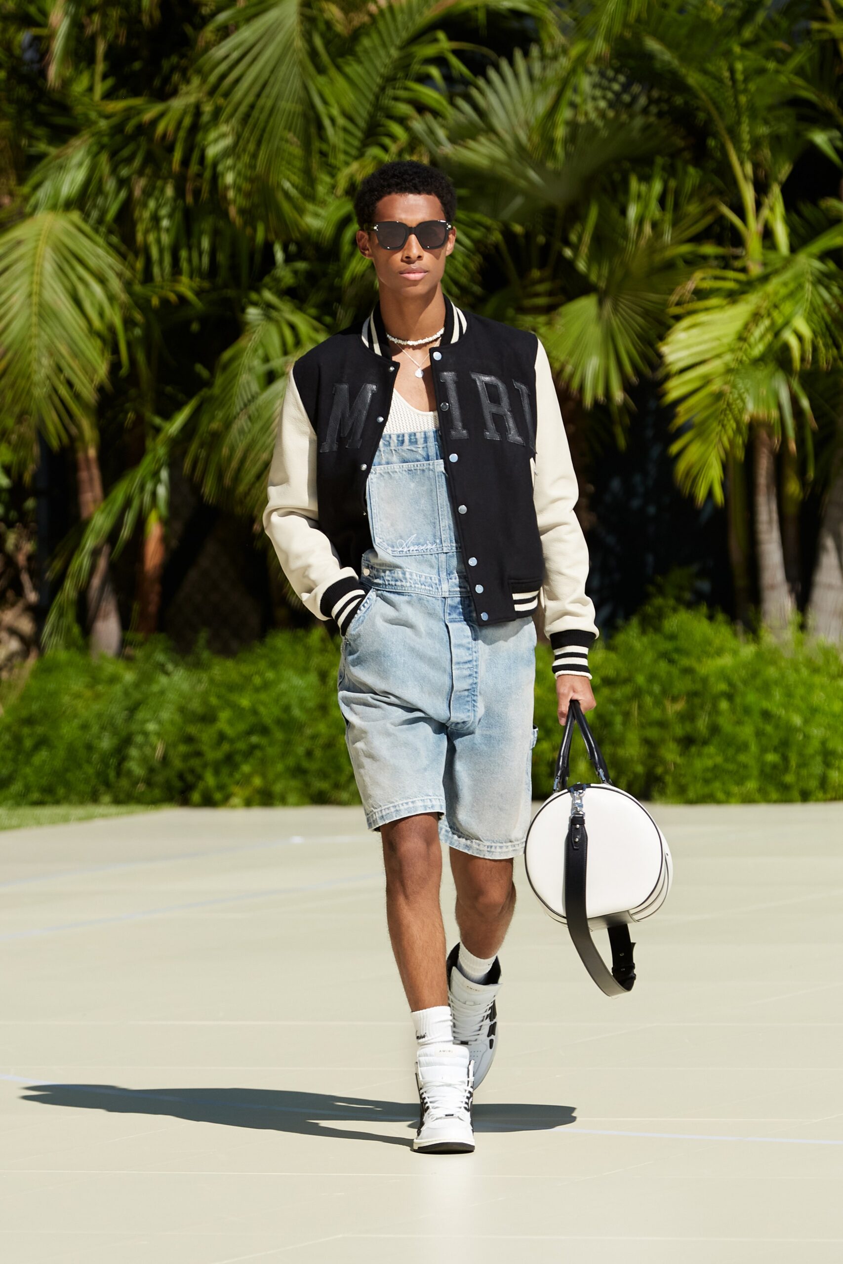black and white jacket with denim overalls