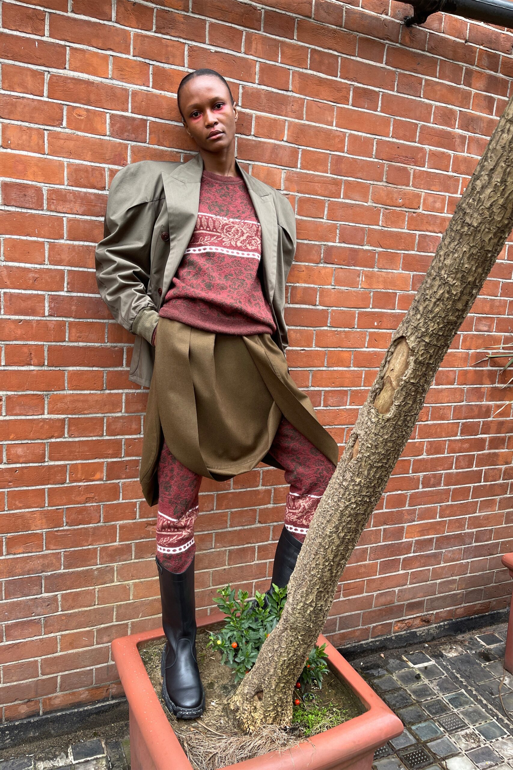 gray oversized jacket with red sweater