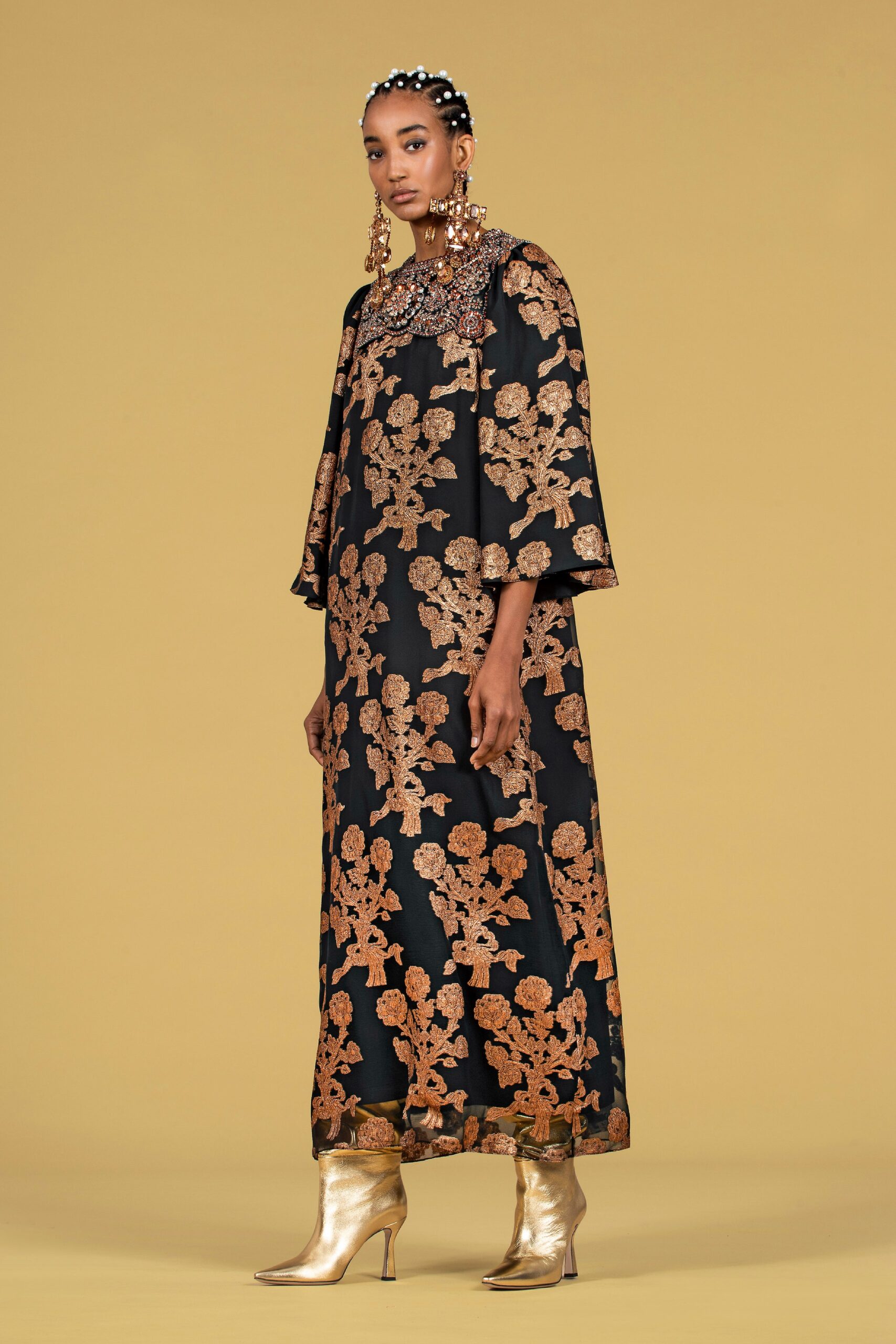 black embroidered maxi gown with gold boots