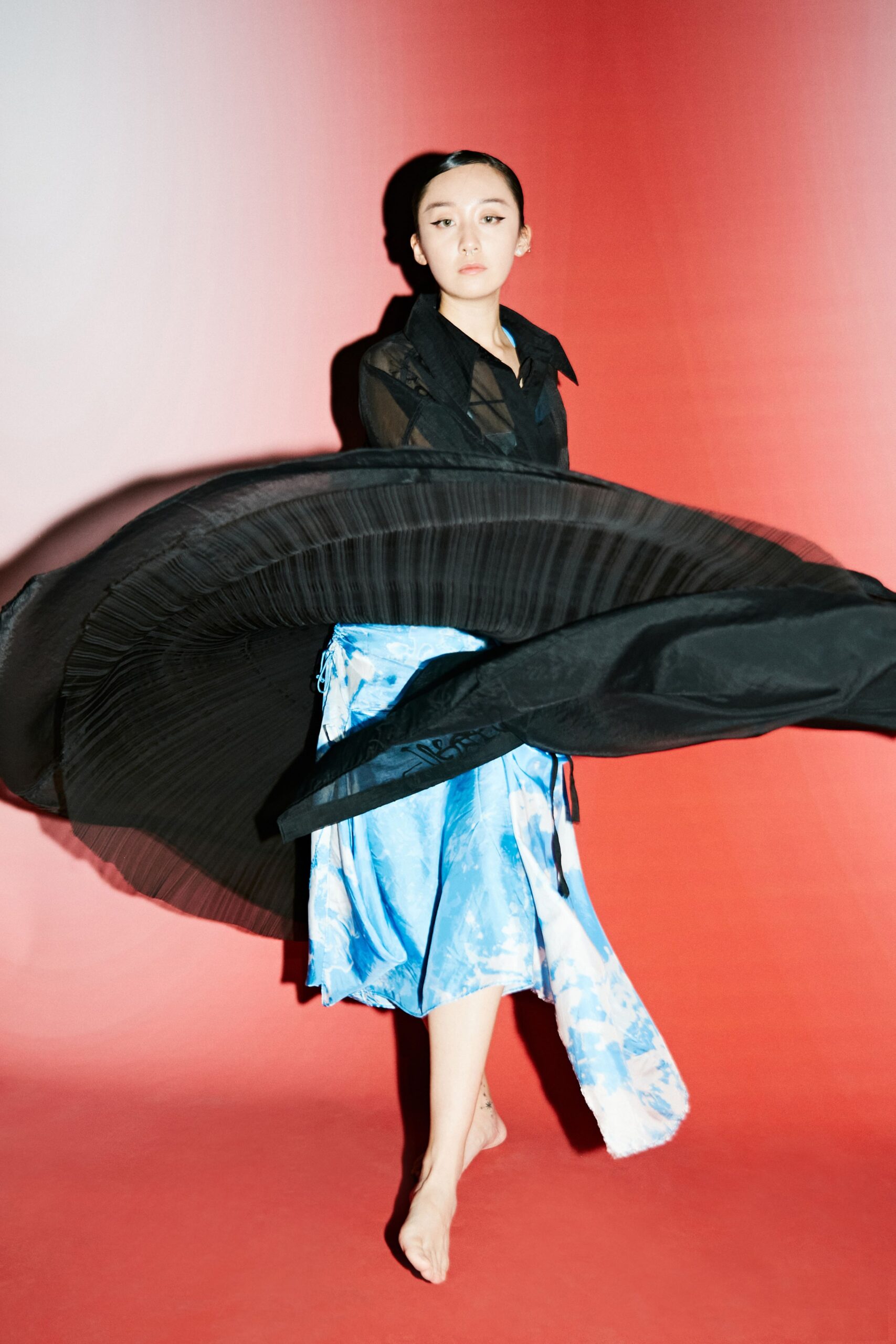 black silk pleated dress and blue layered skirt