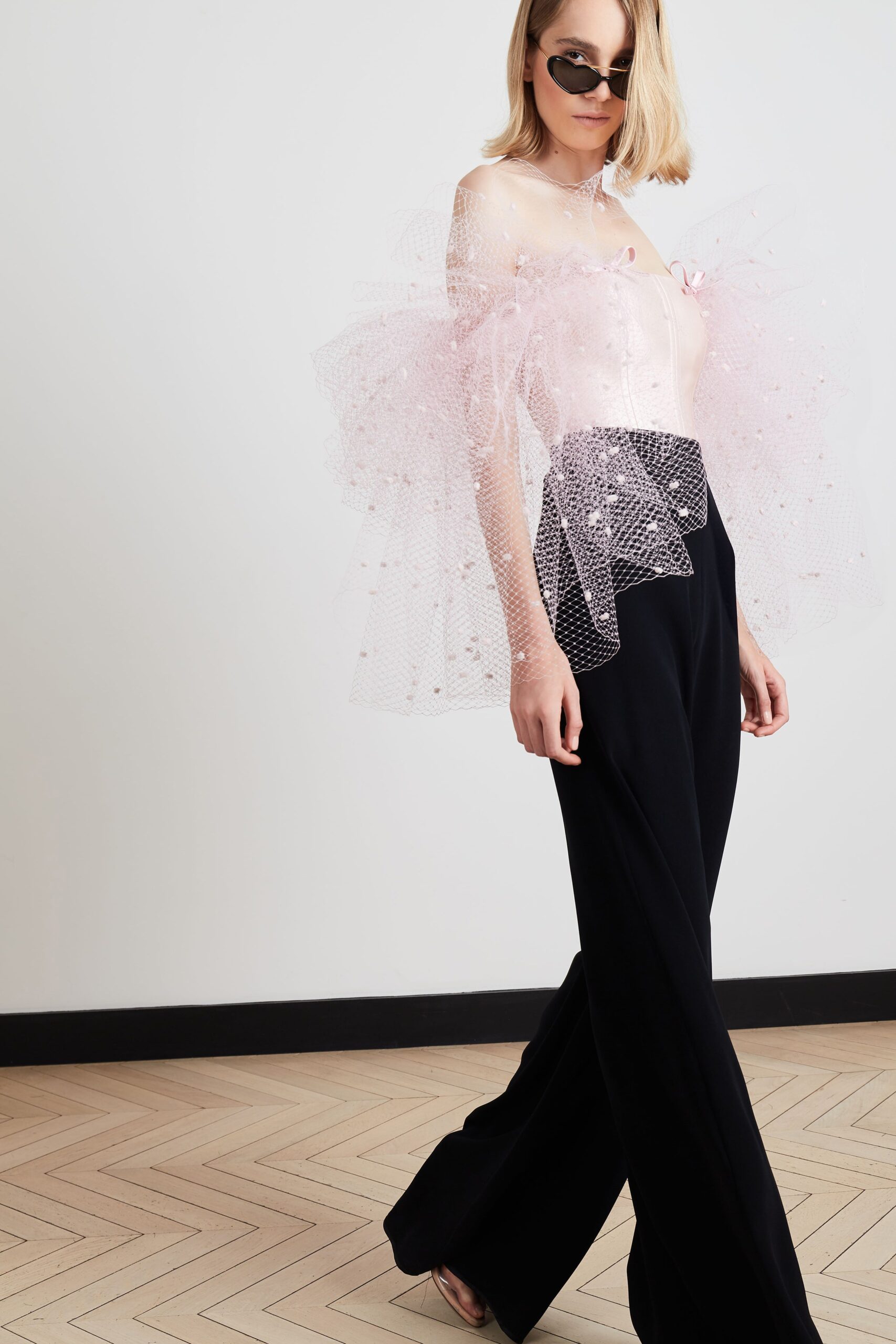 pink tulle off-shoulder top with black pants