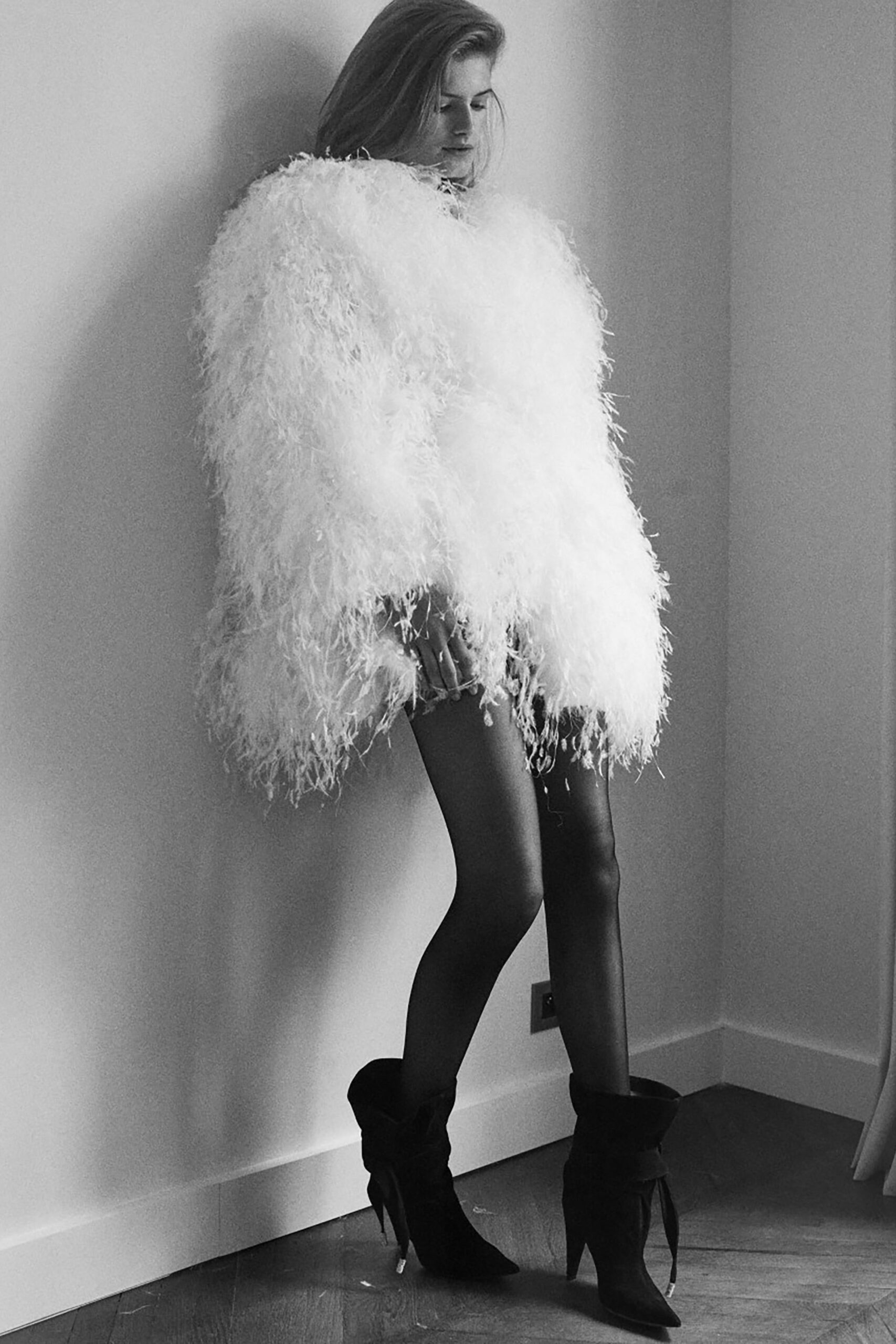 white oversized fur coat and black boots