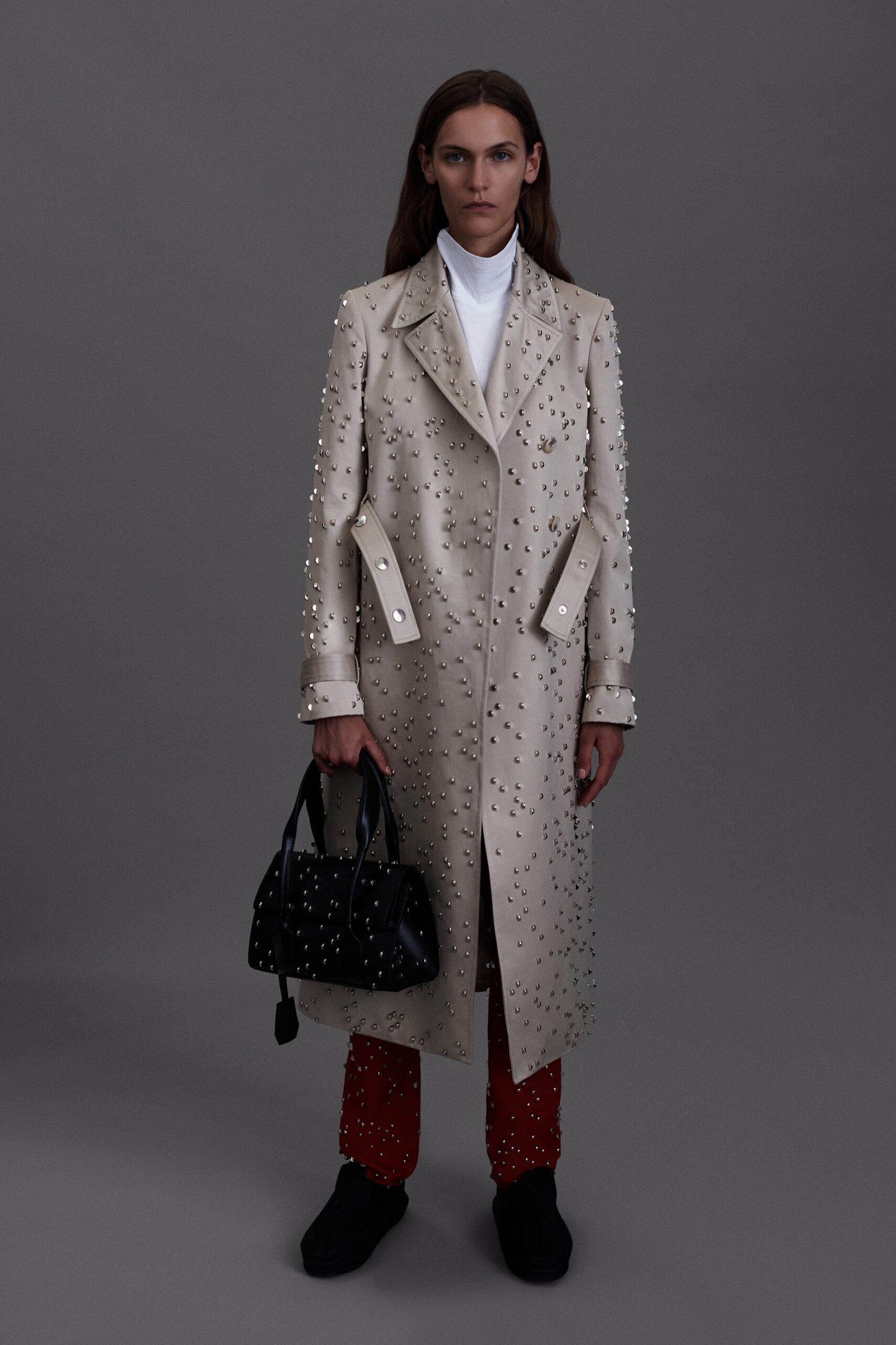 beige embellished coat with red pants