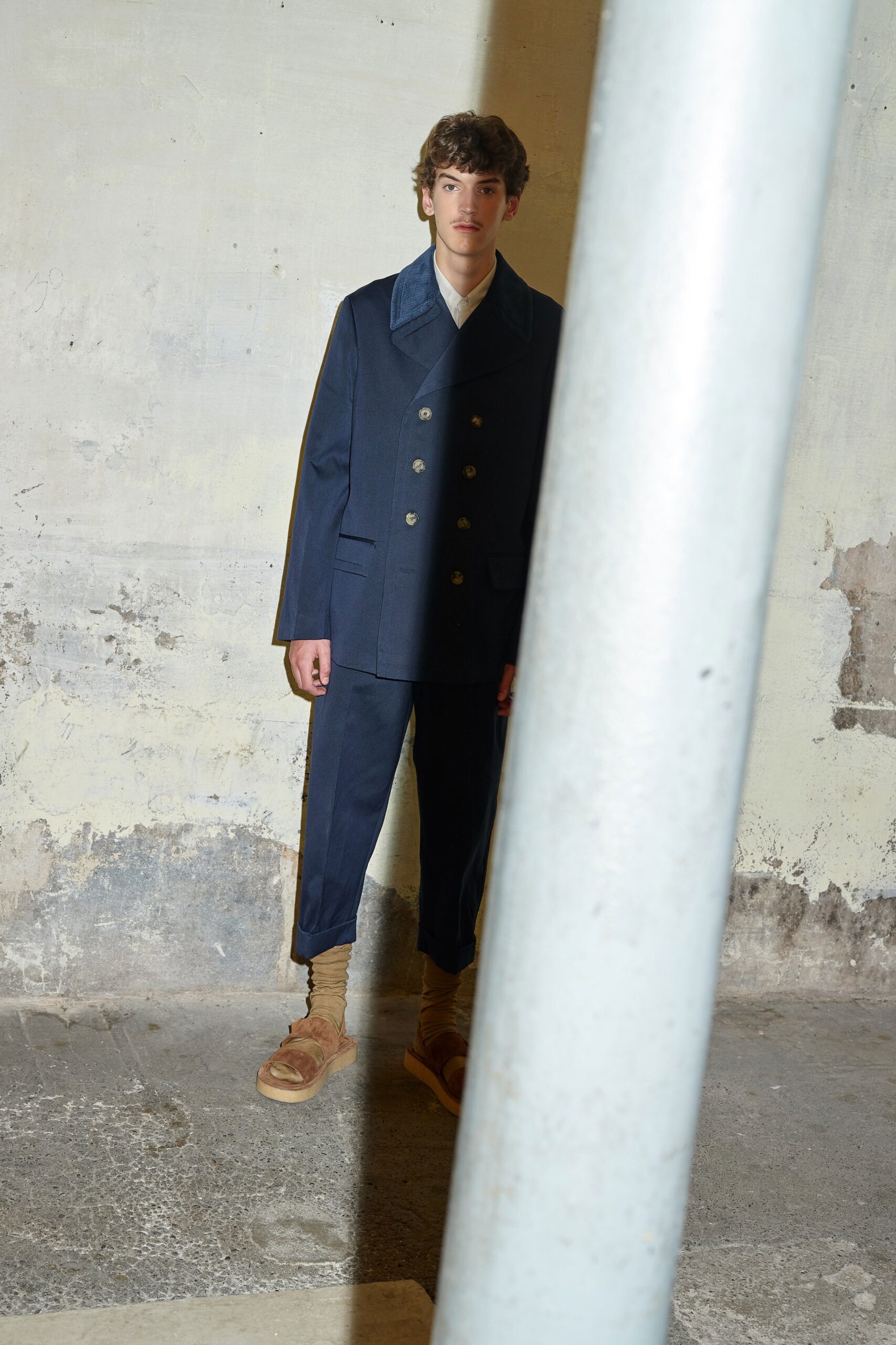 blue tailored suit with brown shoes