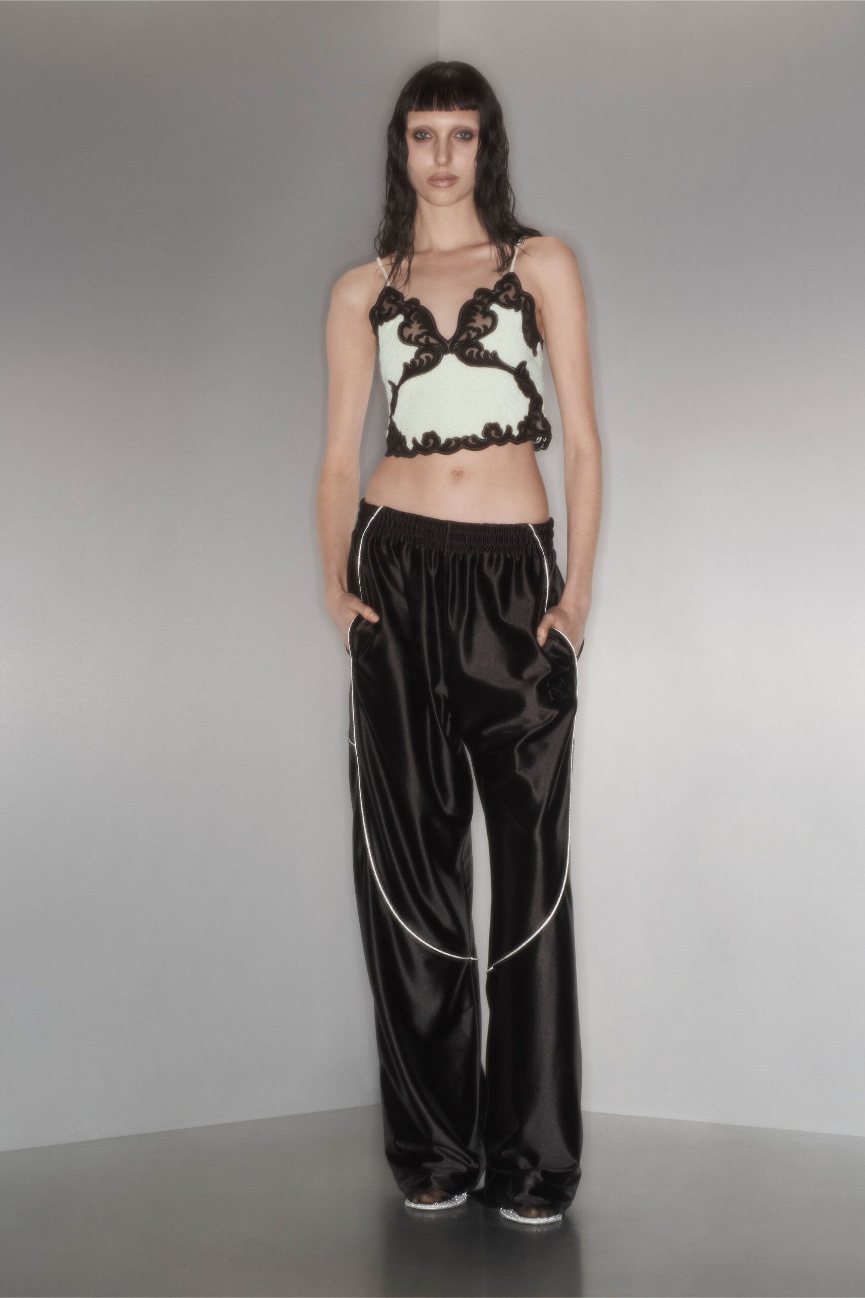 black satin wide-leg pants and embroidered top