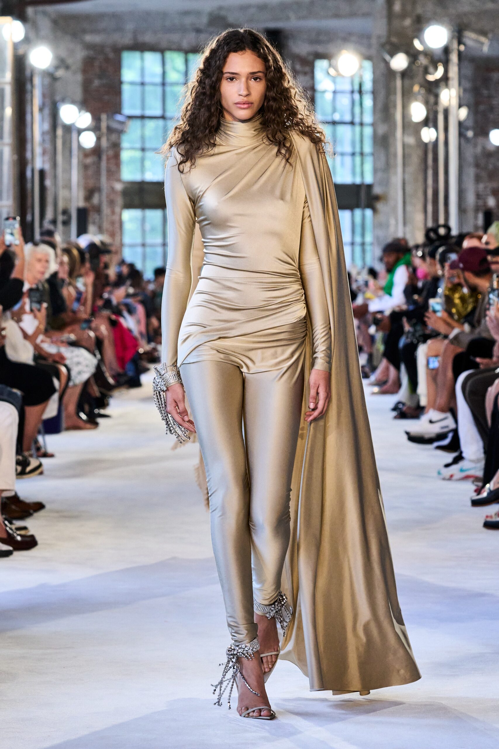 gold silk fitted catsuit with cape
