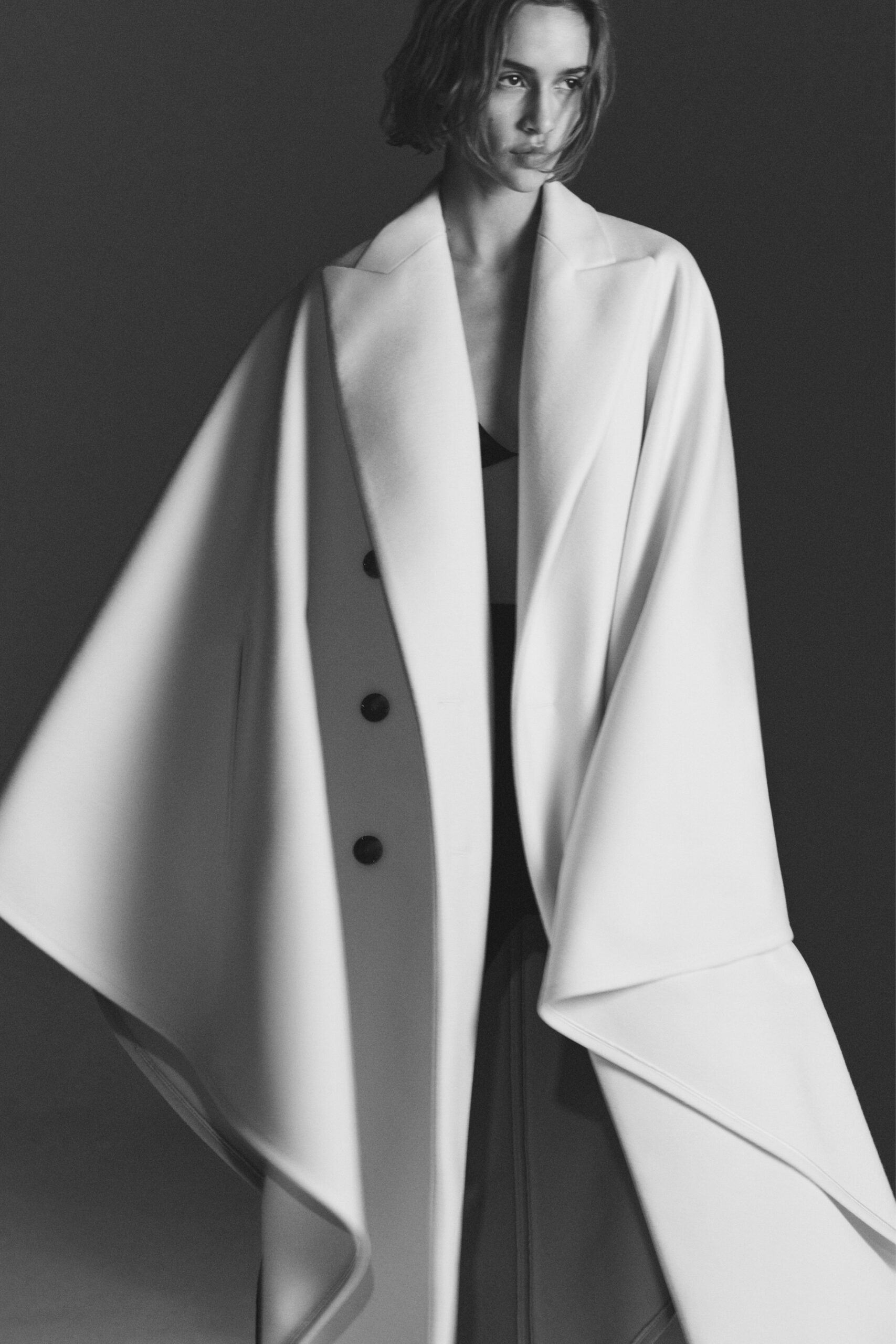 white wool long-sleeve collared structured buttoned cape