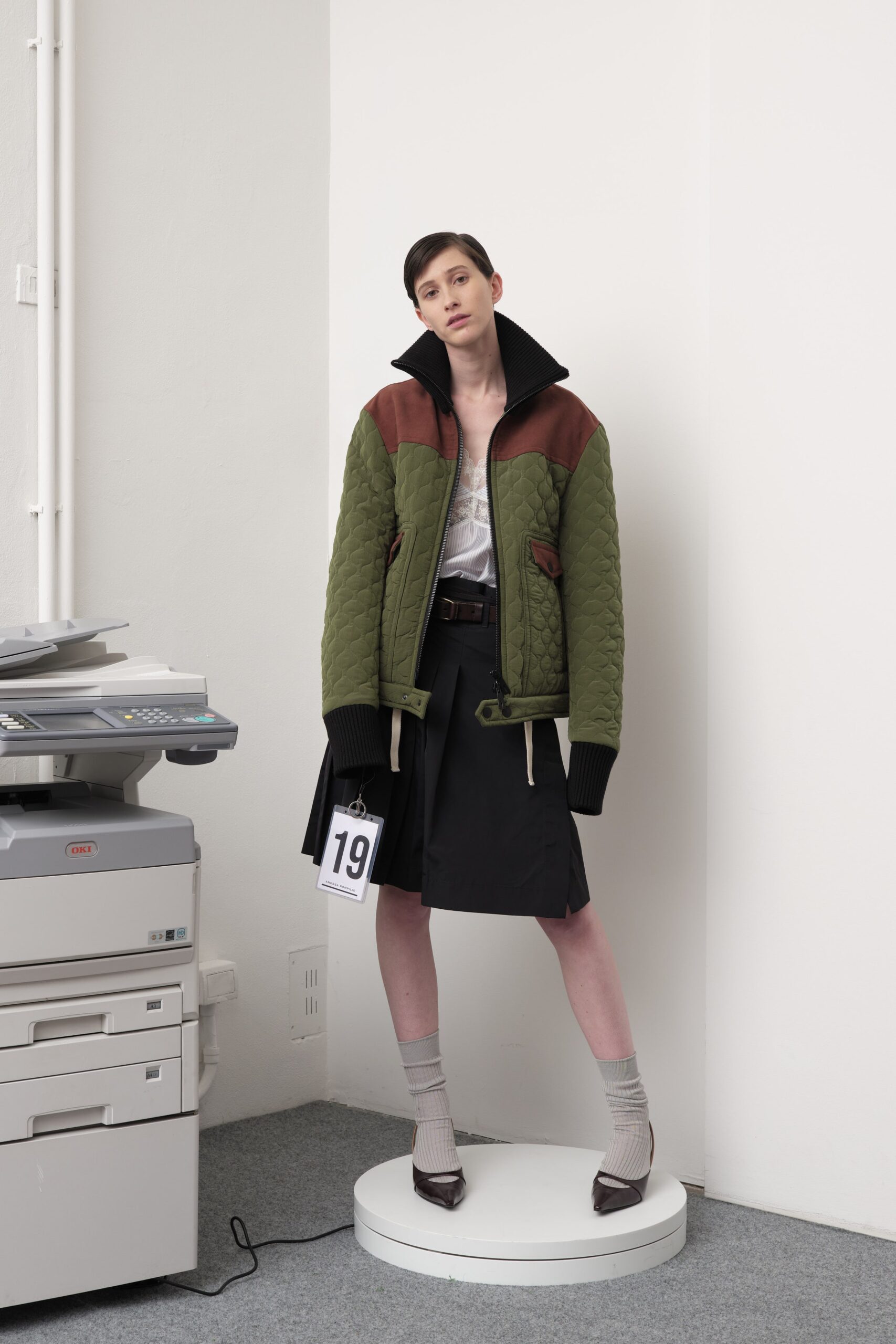 green quilted jacket with black skirt