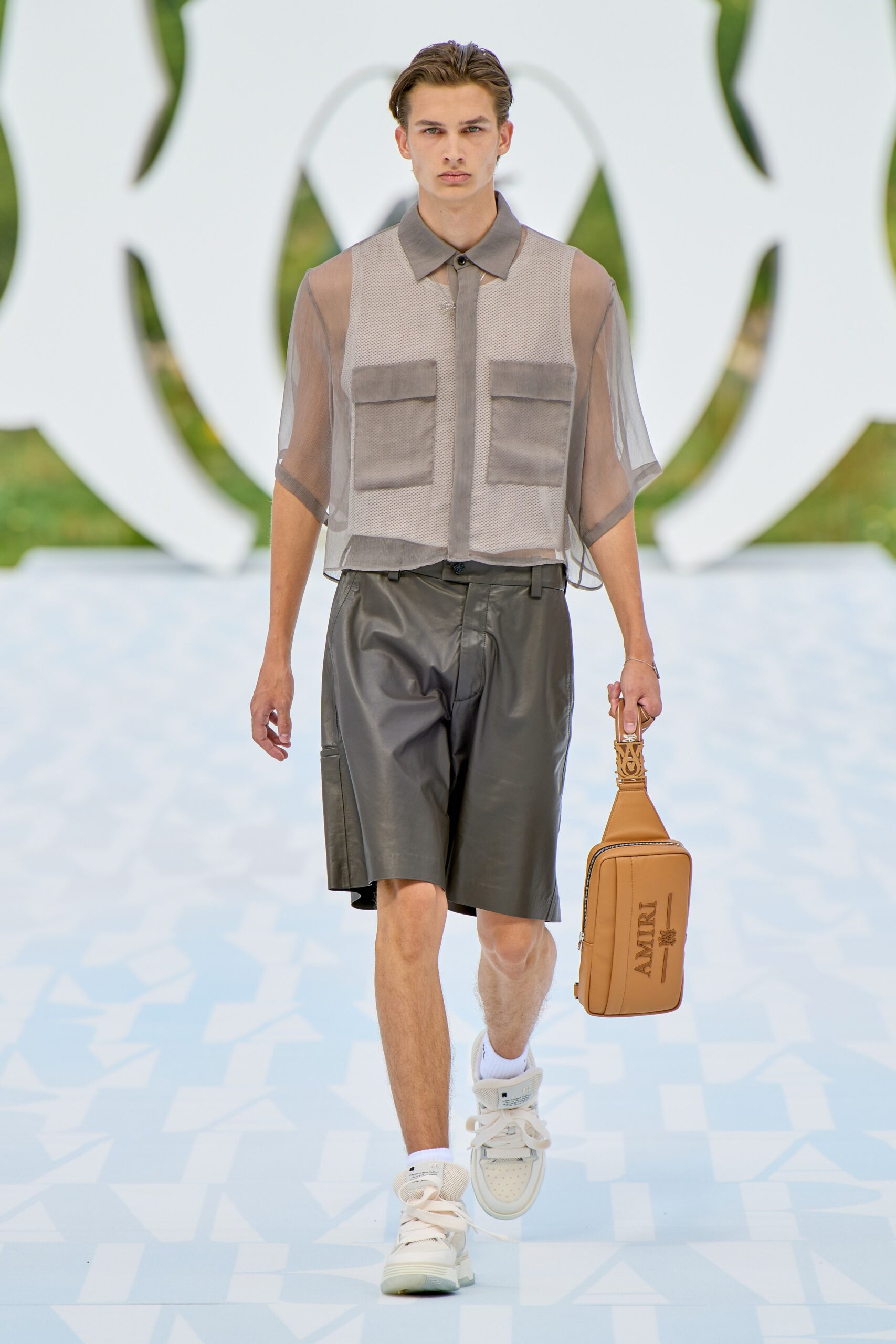 beige mesh shirt with black leather shorts