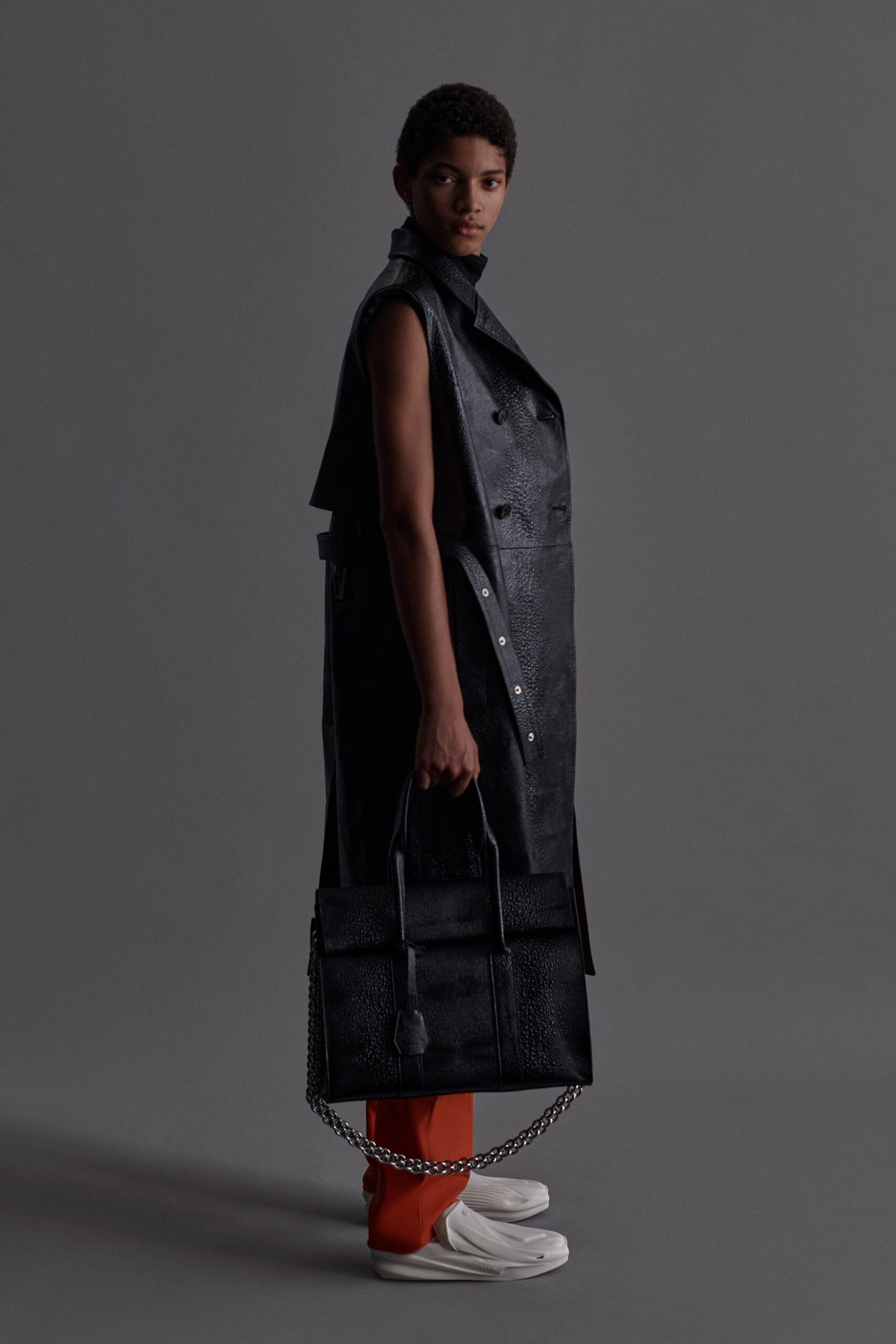 black leather sleeveless high-neck fitted buttoned coat
