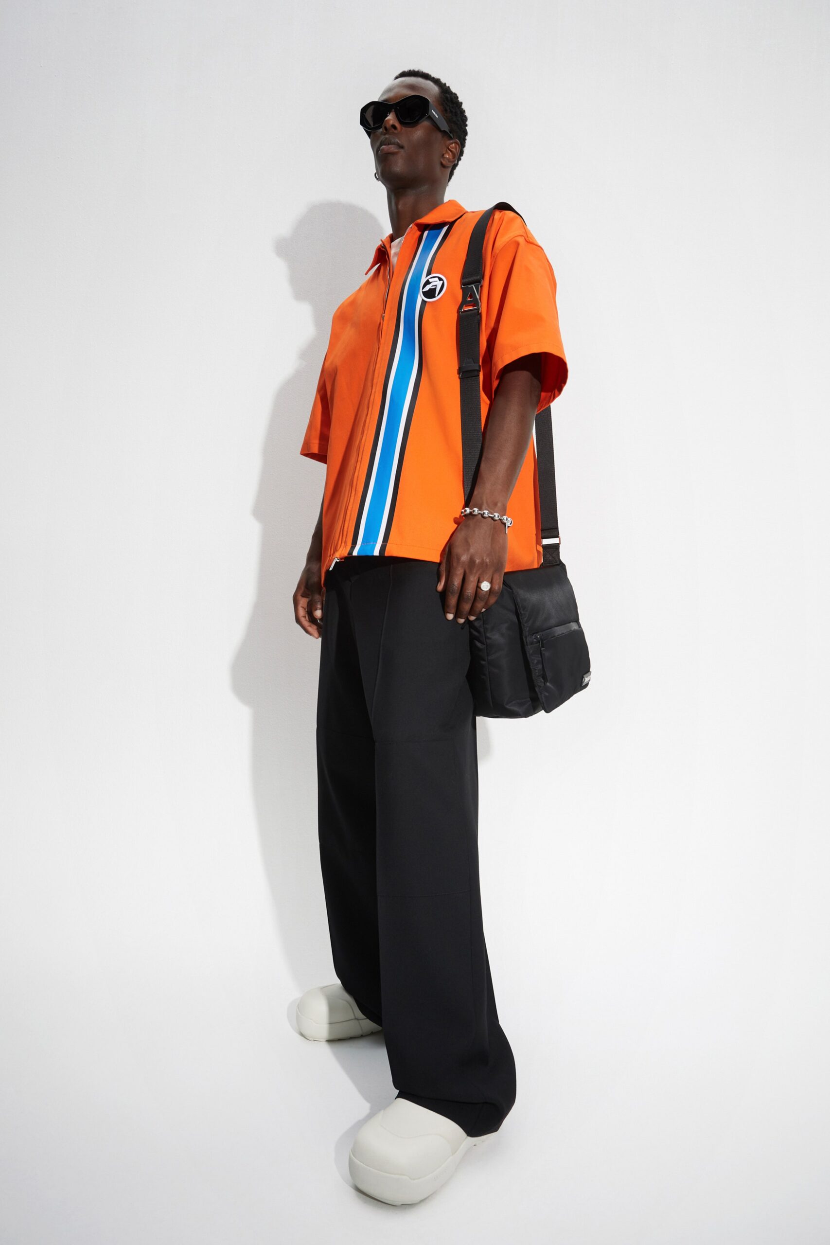 orange color-blocked shirt with black pants