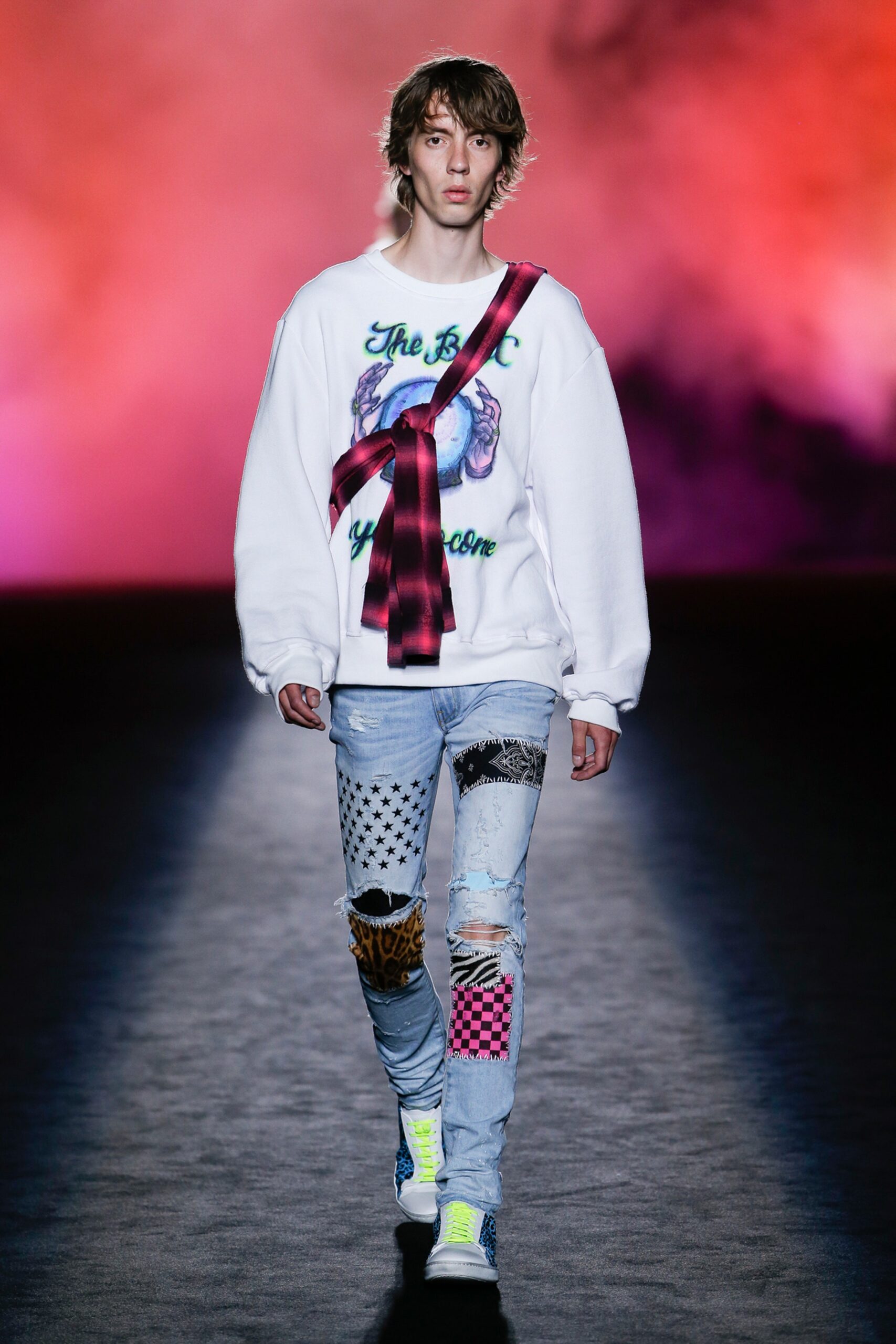 white printed relaxed sweater and blue jeans