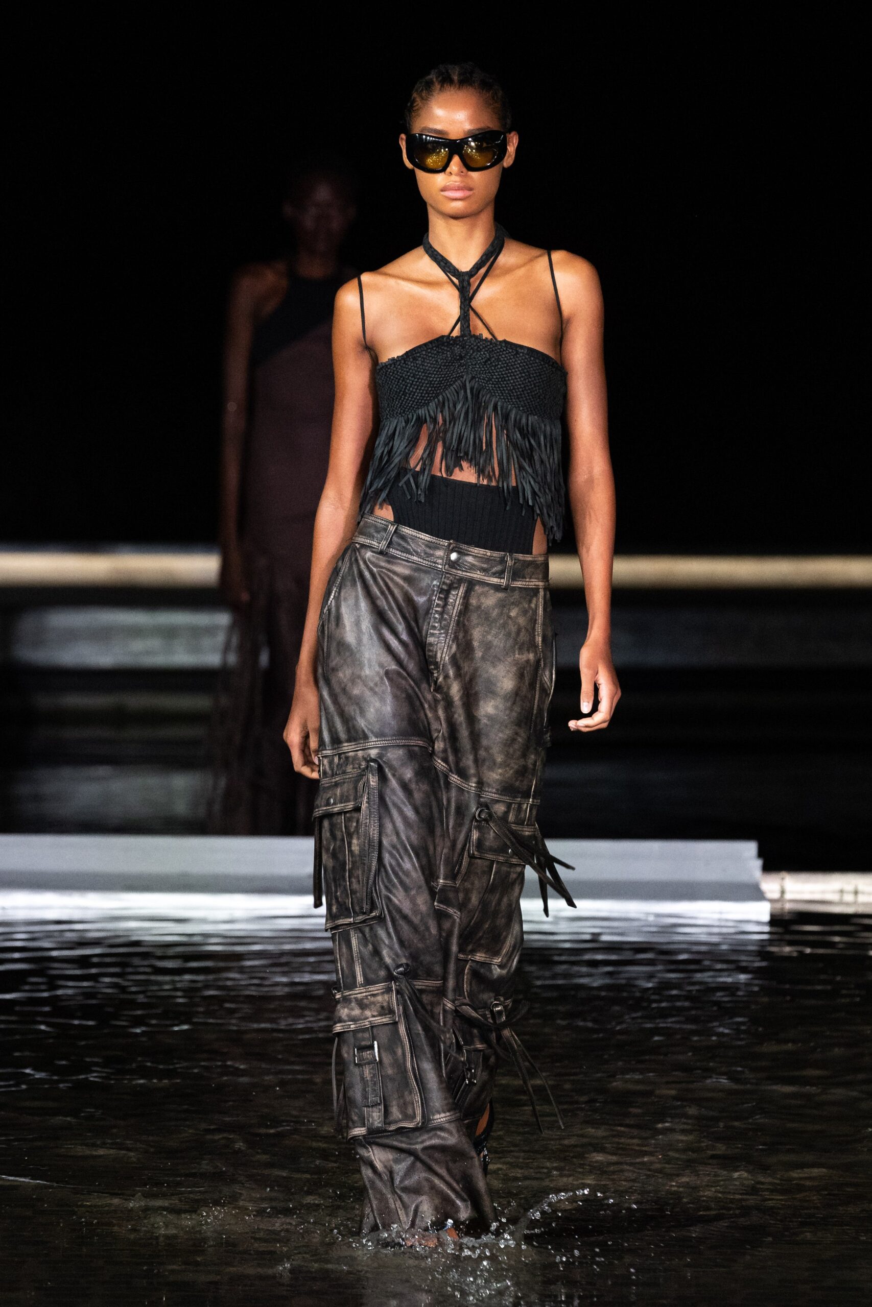black fringed top and brown cargo pants
