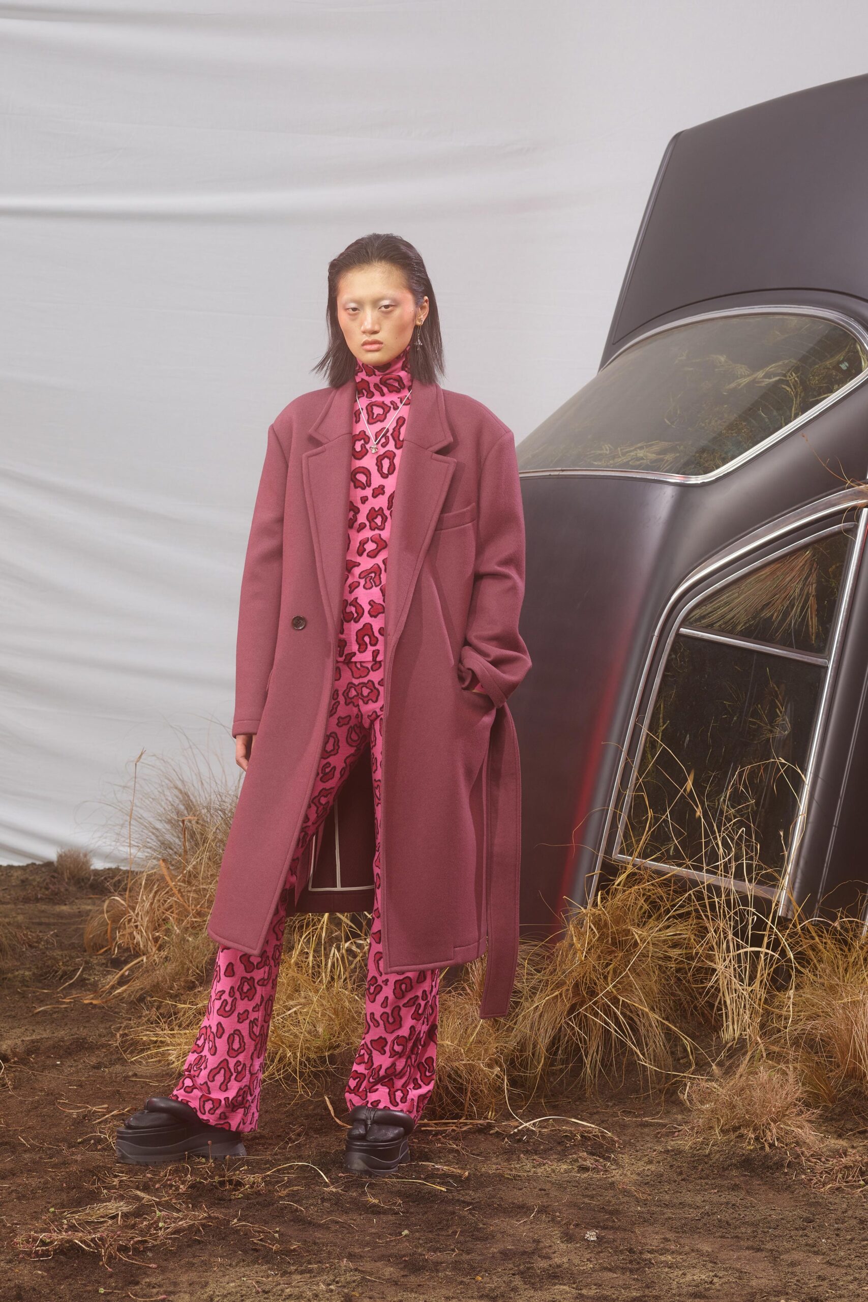 purple wool coat and pink jumpsuit