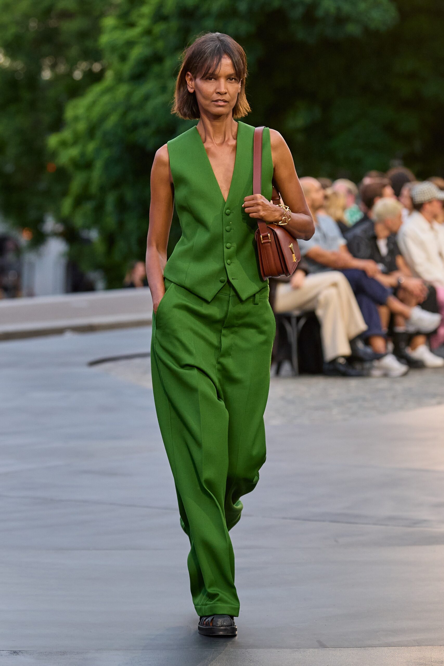 green fitted vest and relaxed pants